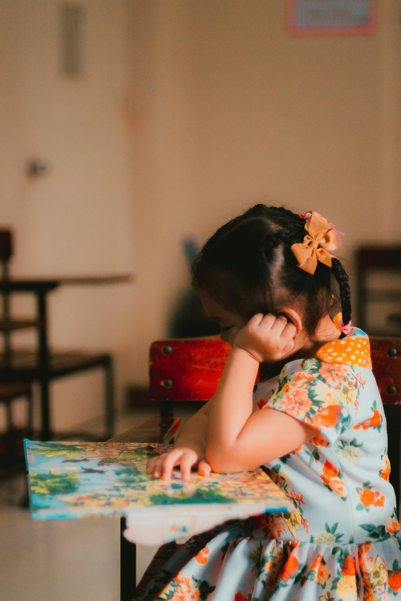A young girl reading a book. 