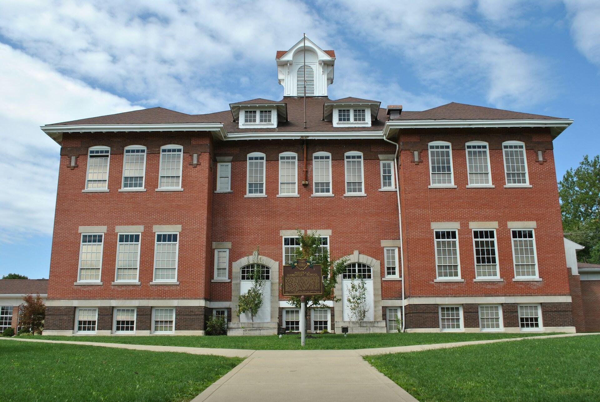 A large stone building on a partly cloudy day.