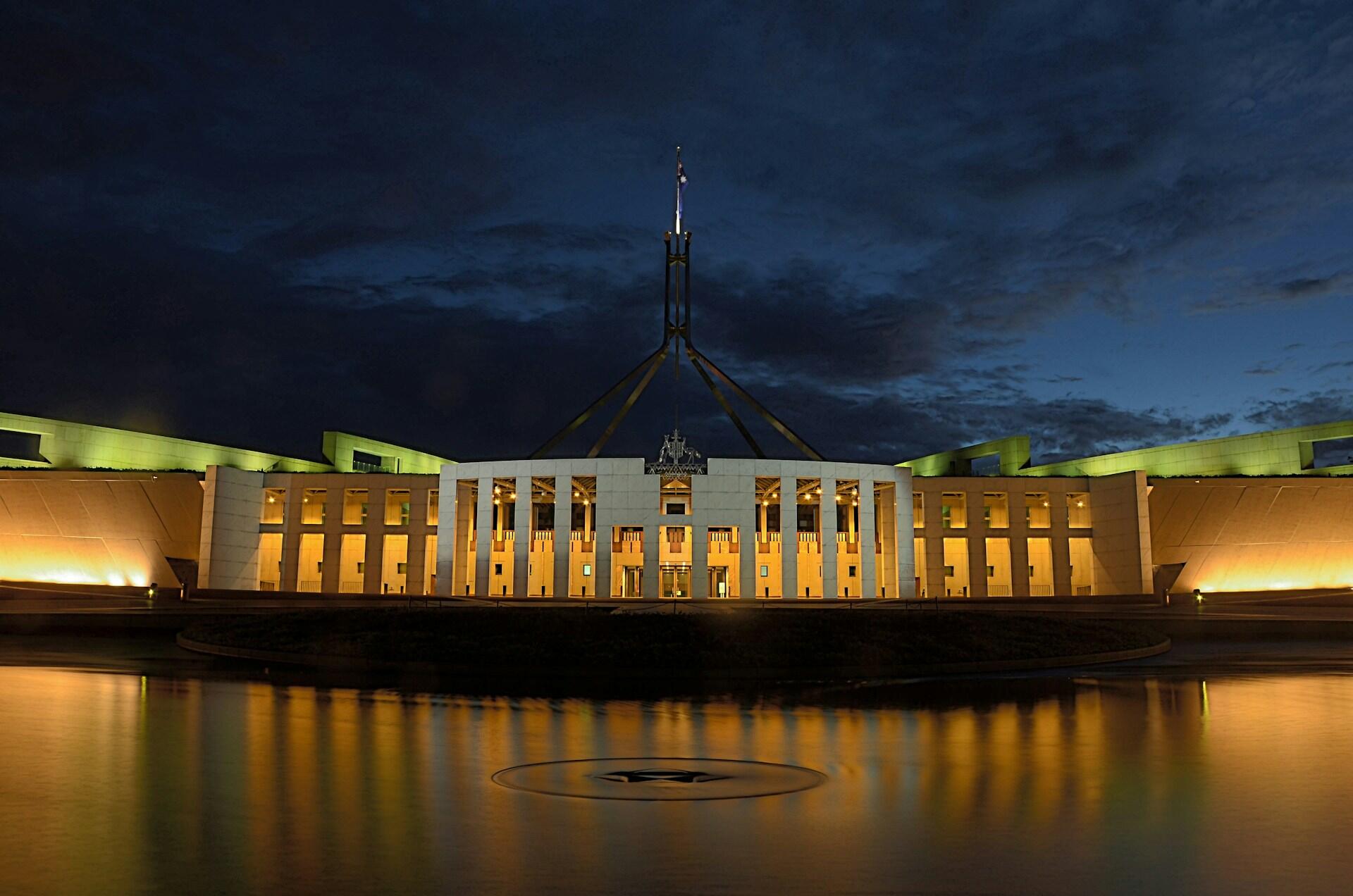 A stylish building lit up at night.