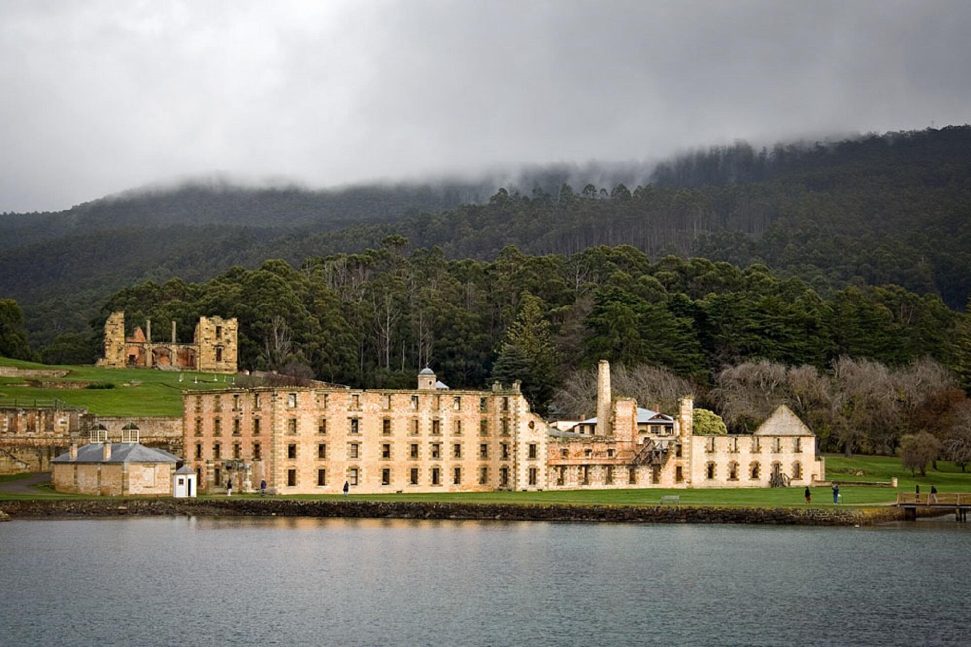 A light-coloured stone building near water.