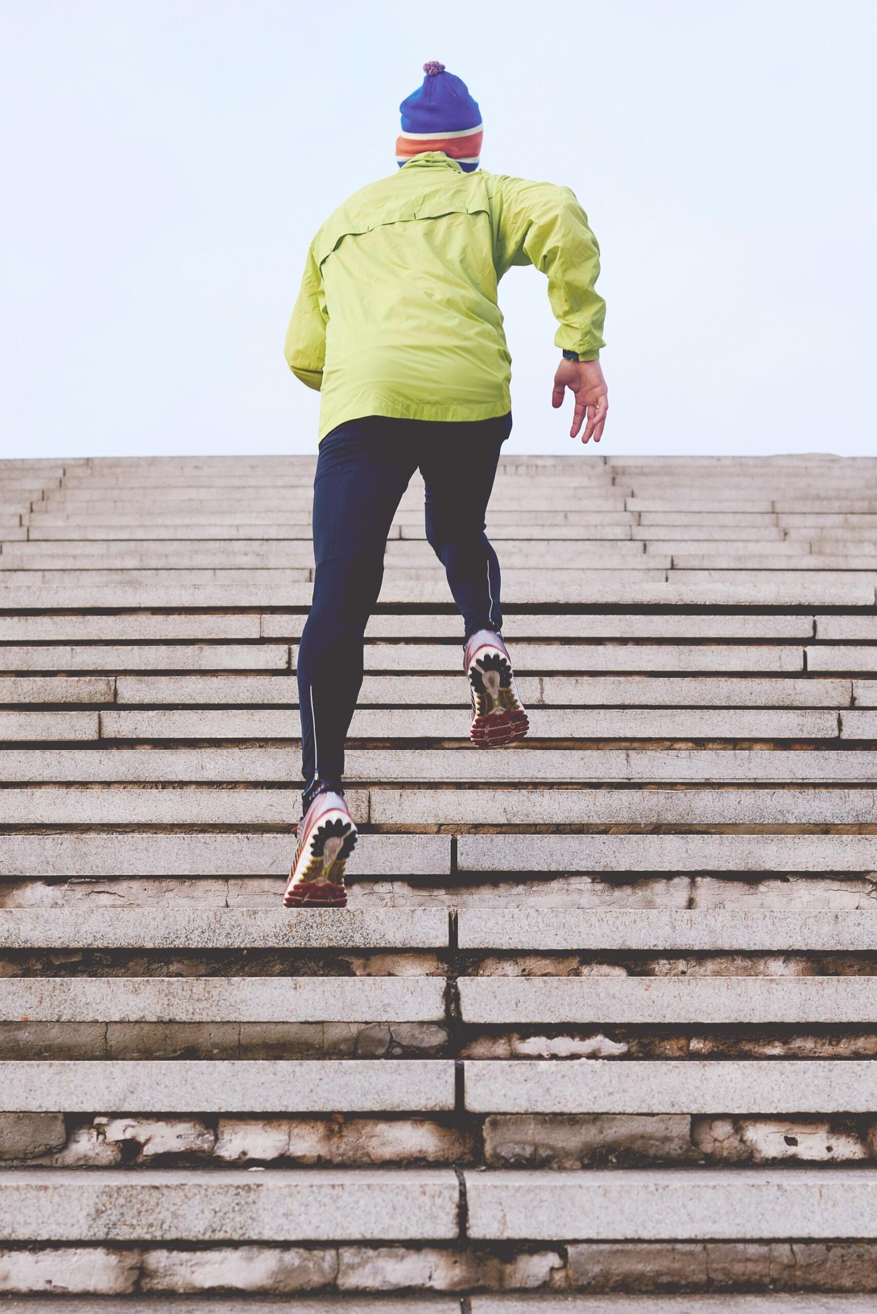 man running up a flight of stairs outdoors