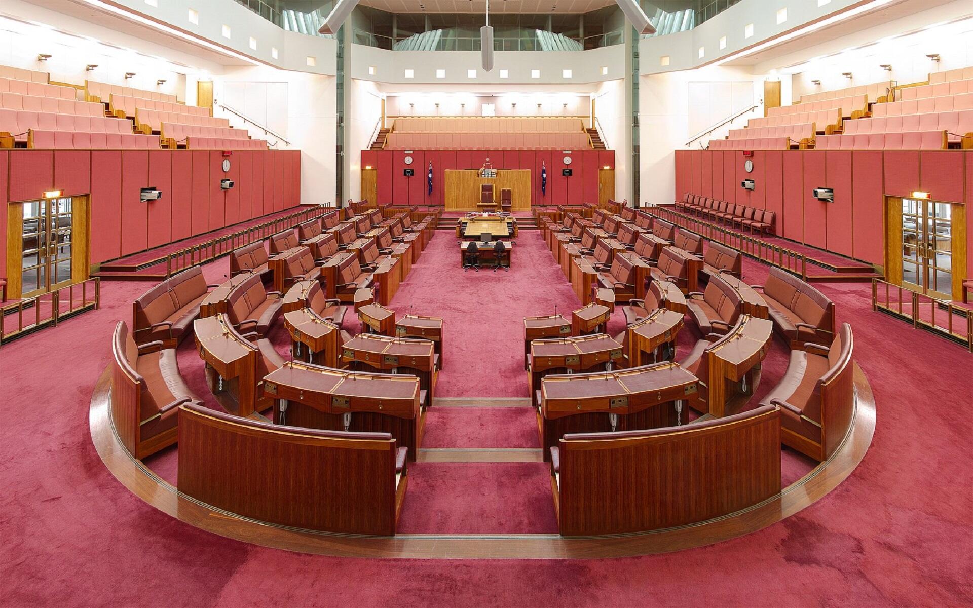 A large room with wooden furniture and red accents.