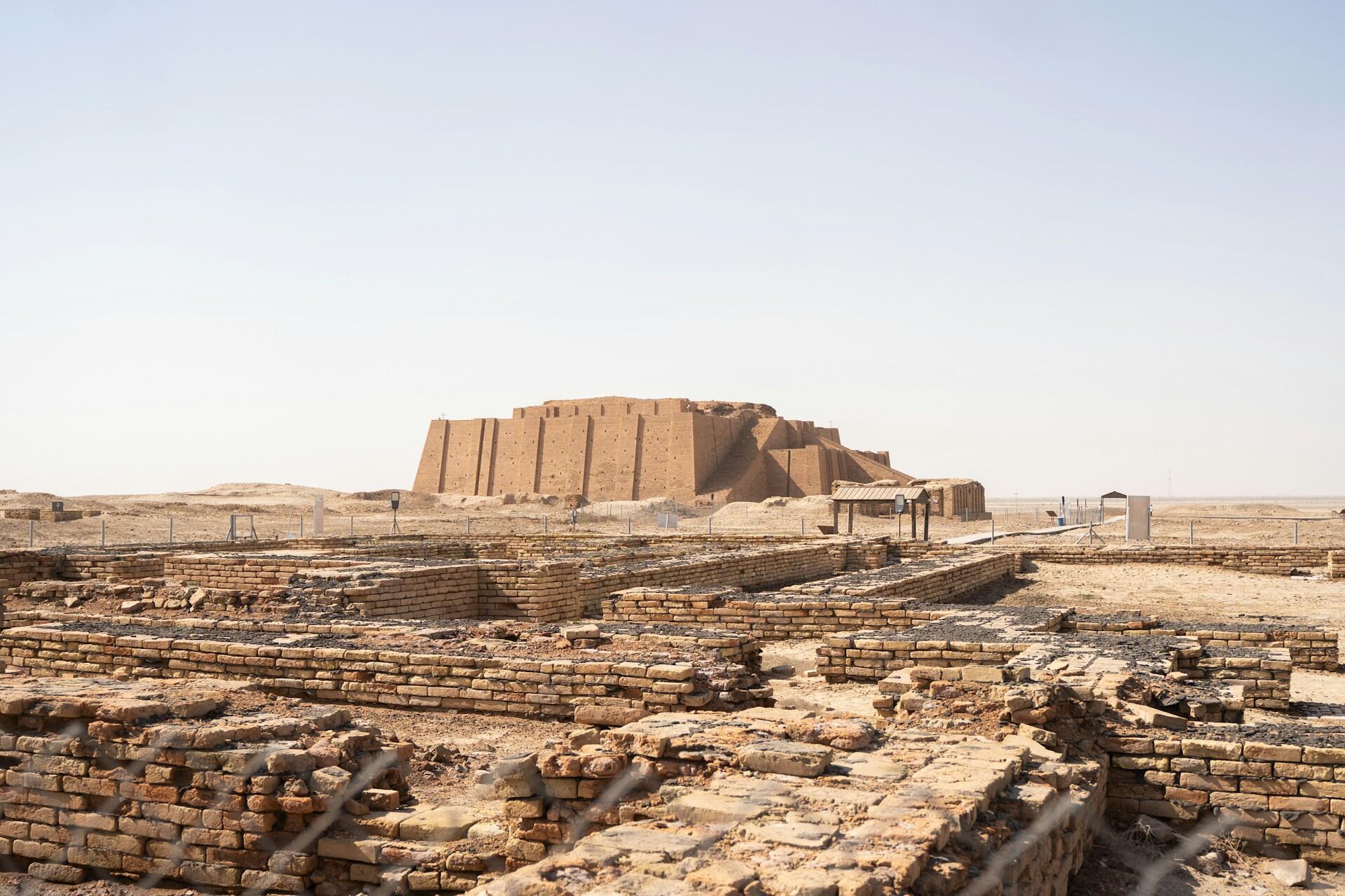 A vast site of ancient ruins, under a clear sky.