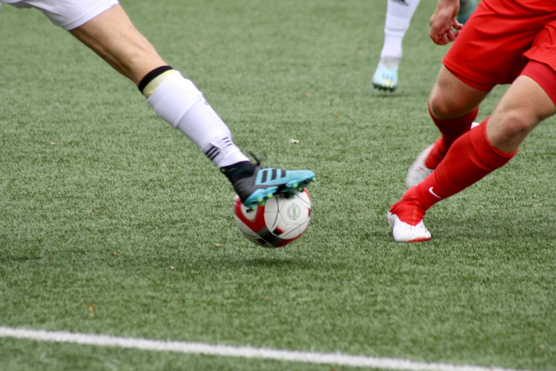 Two players contesting a ball in football.