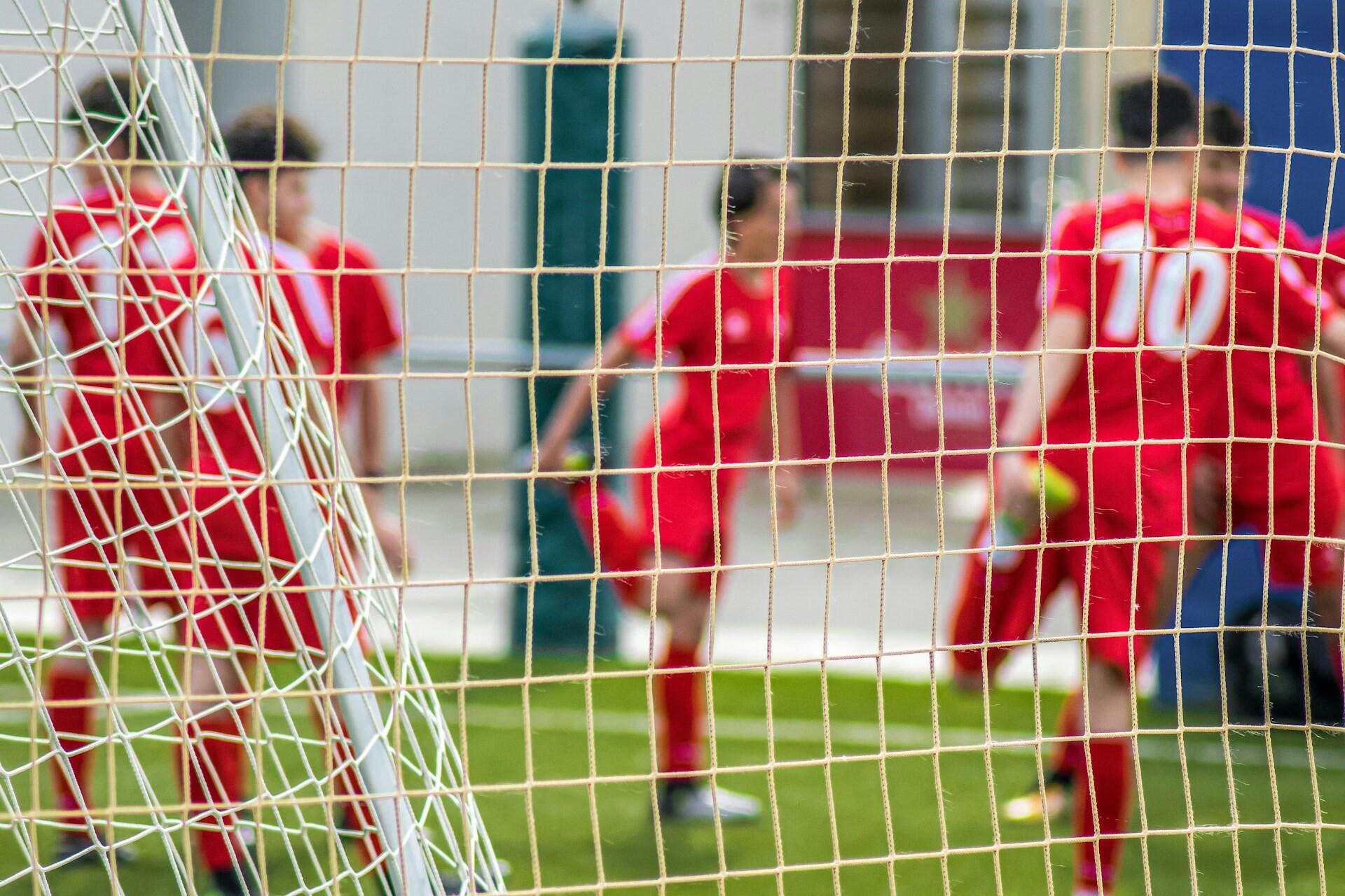 Football players warming up and stretching.