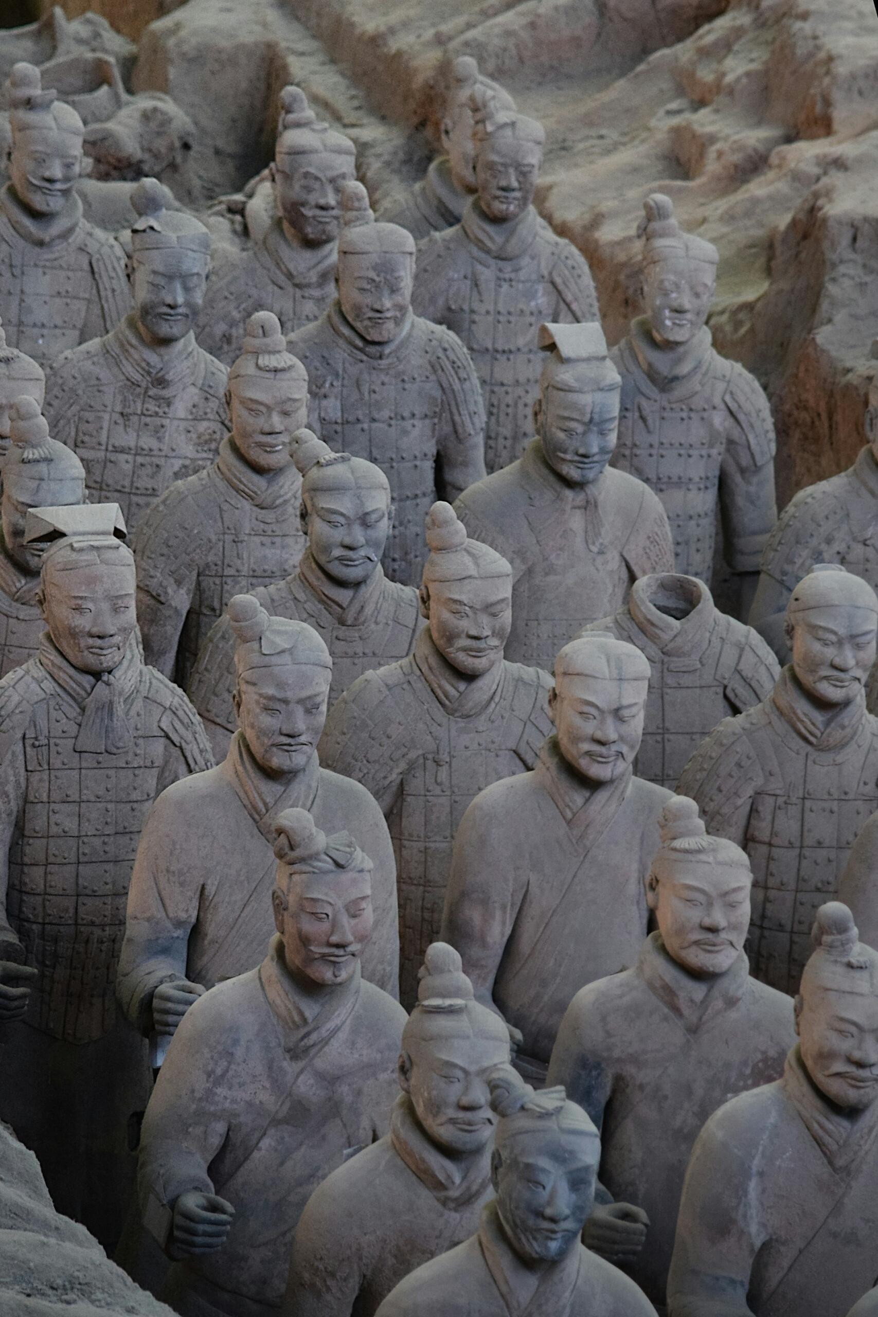 Terracotta soldiers standing closely in an excavation site, showcasing ancient Chinese craftsmanship and military history.