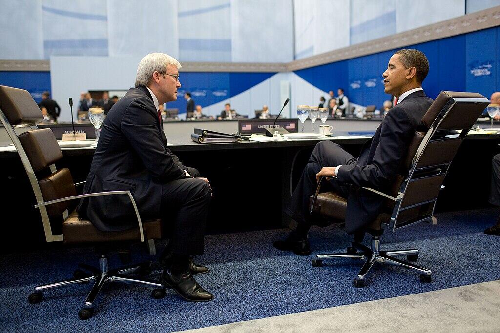 US President Barack Obama and Australian Prime Minister Kevin Rudd seated at a round table during a conference.