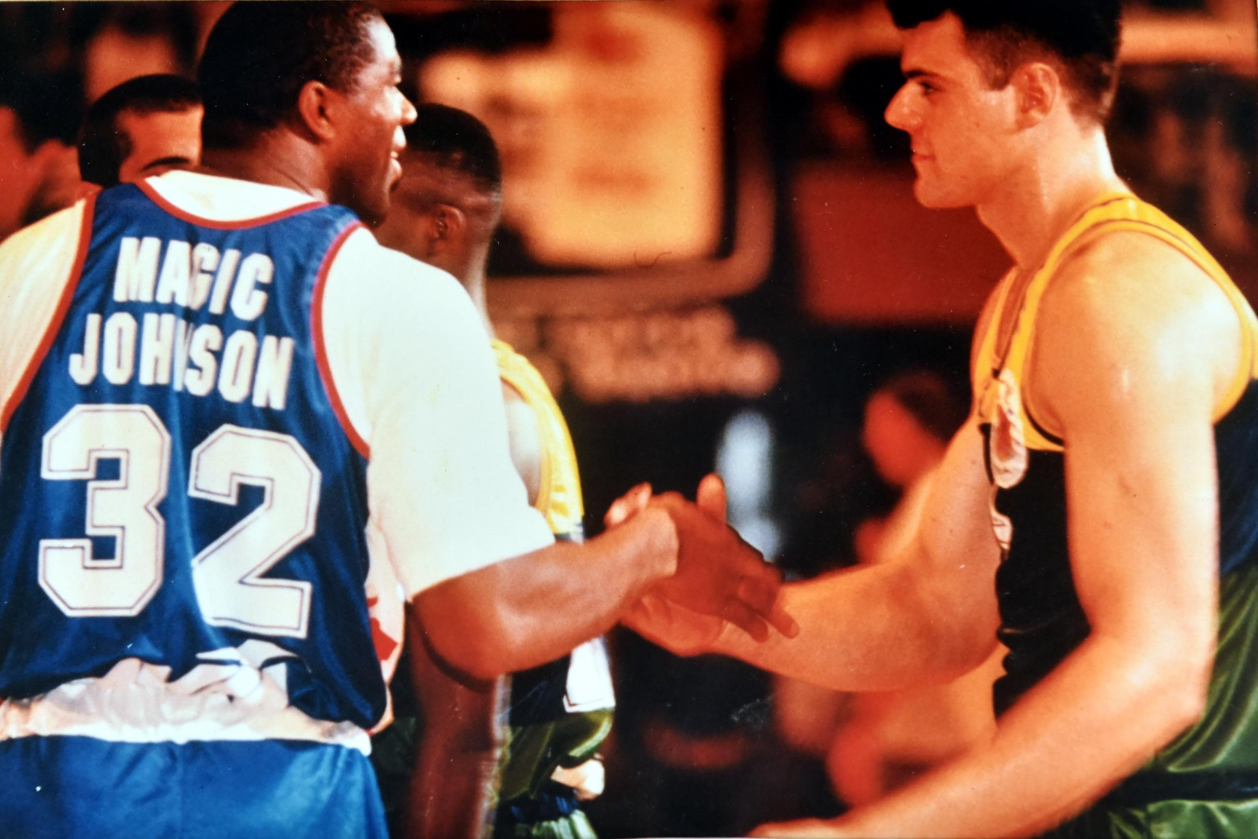 Magic Johnson handshaking with another player.