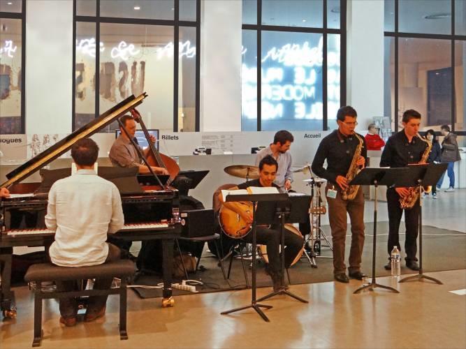 A jazz band performing led by a guitarist