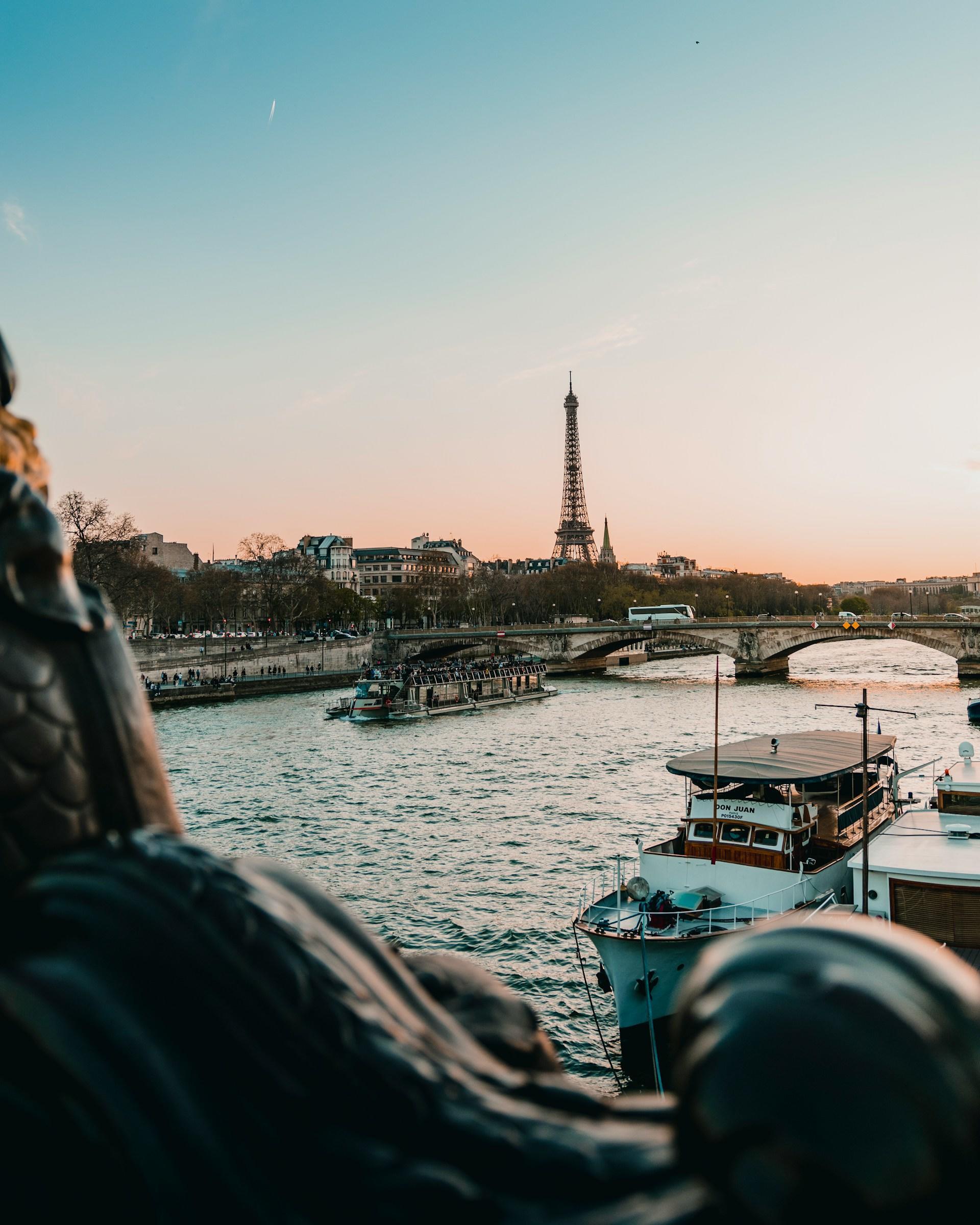 The Seine with the Eiffel Tower in the distance, at sunrise.