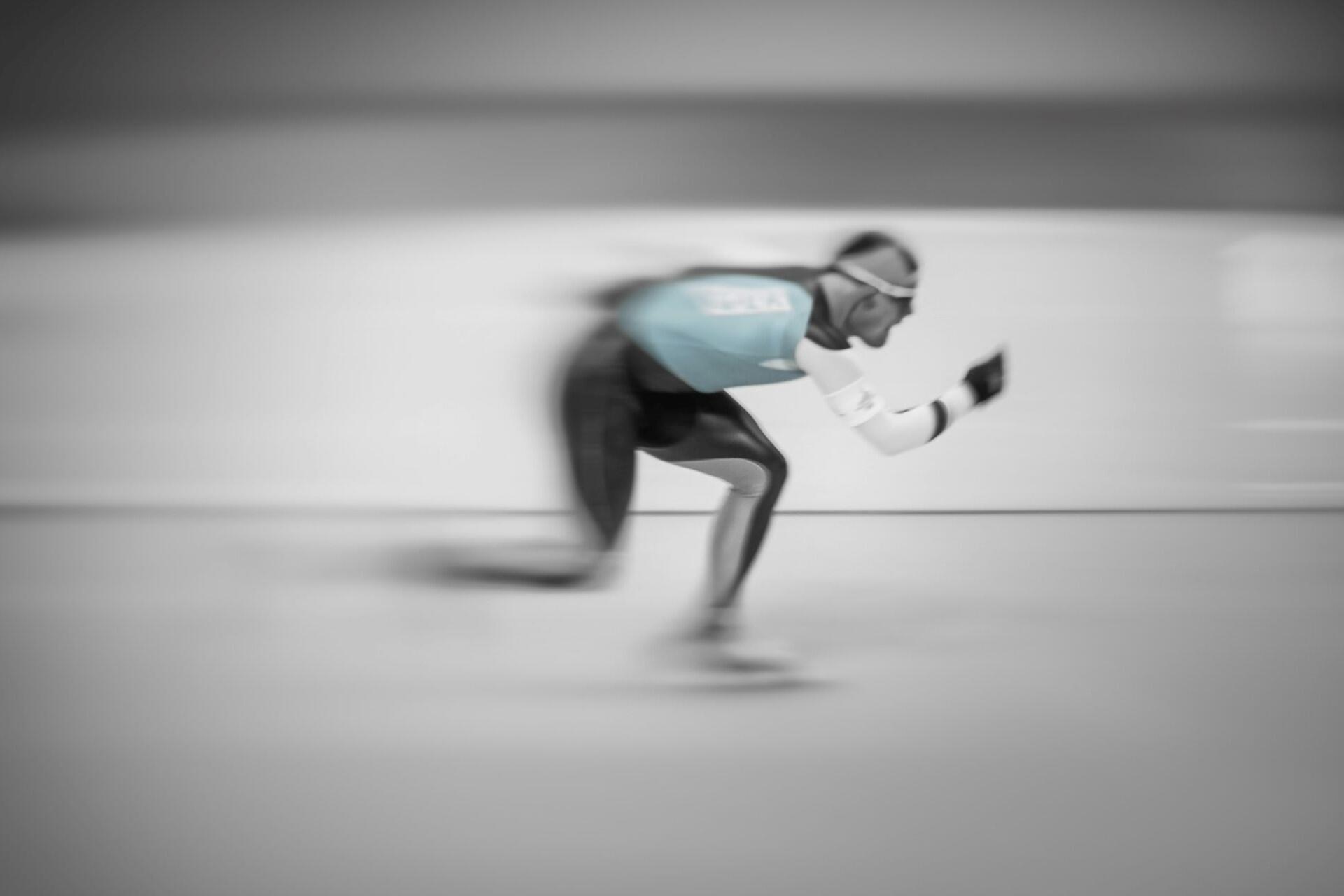 A speed skater skating fast.