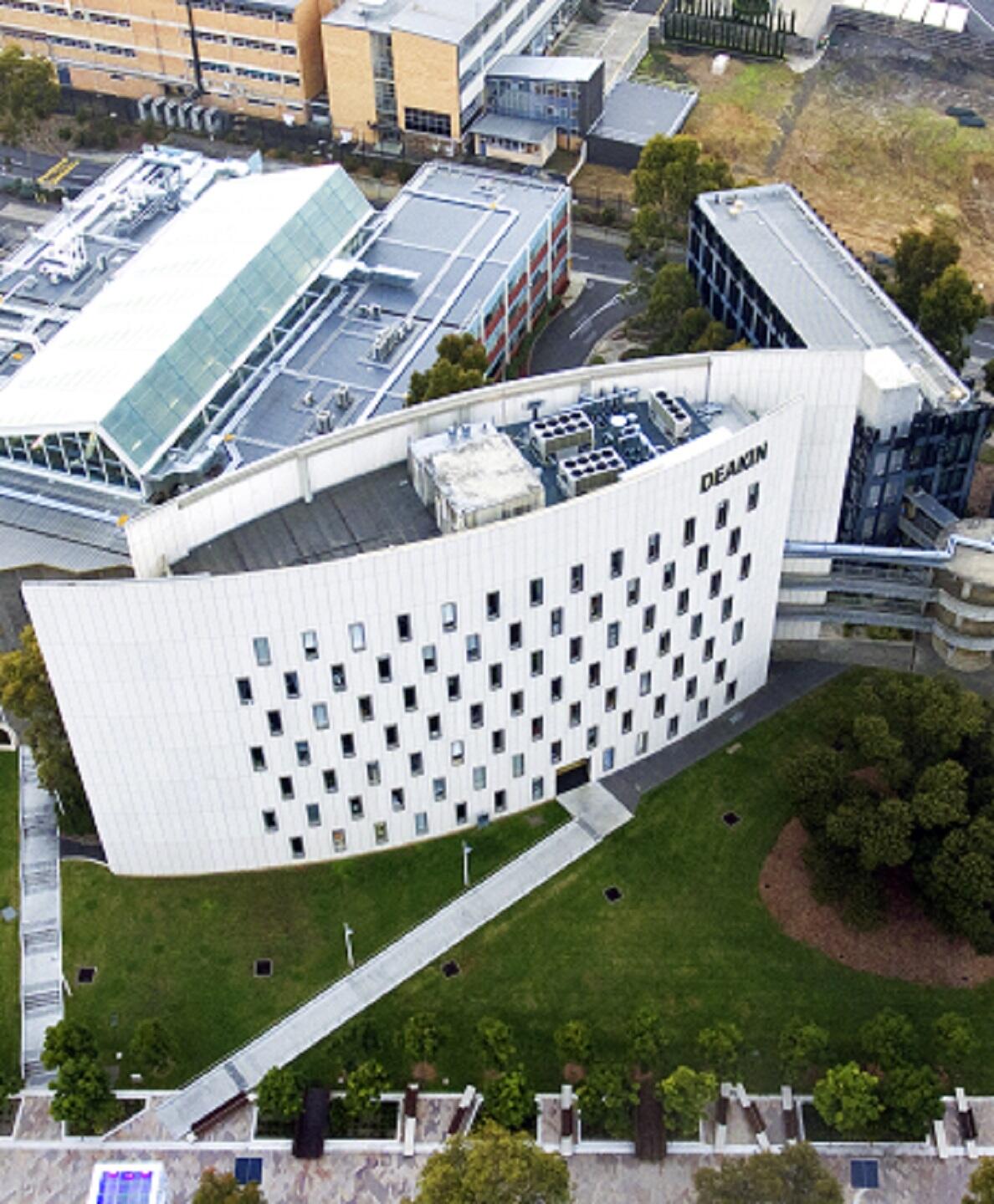 A white building with an unusual shape seen from above.