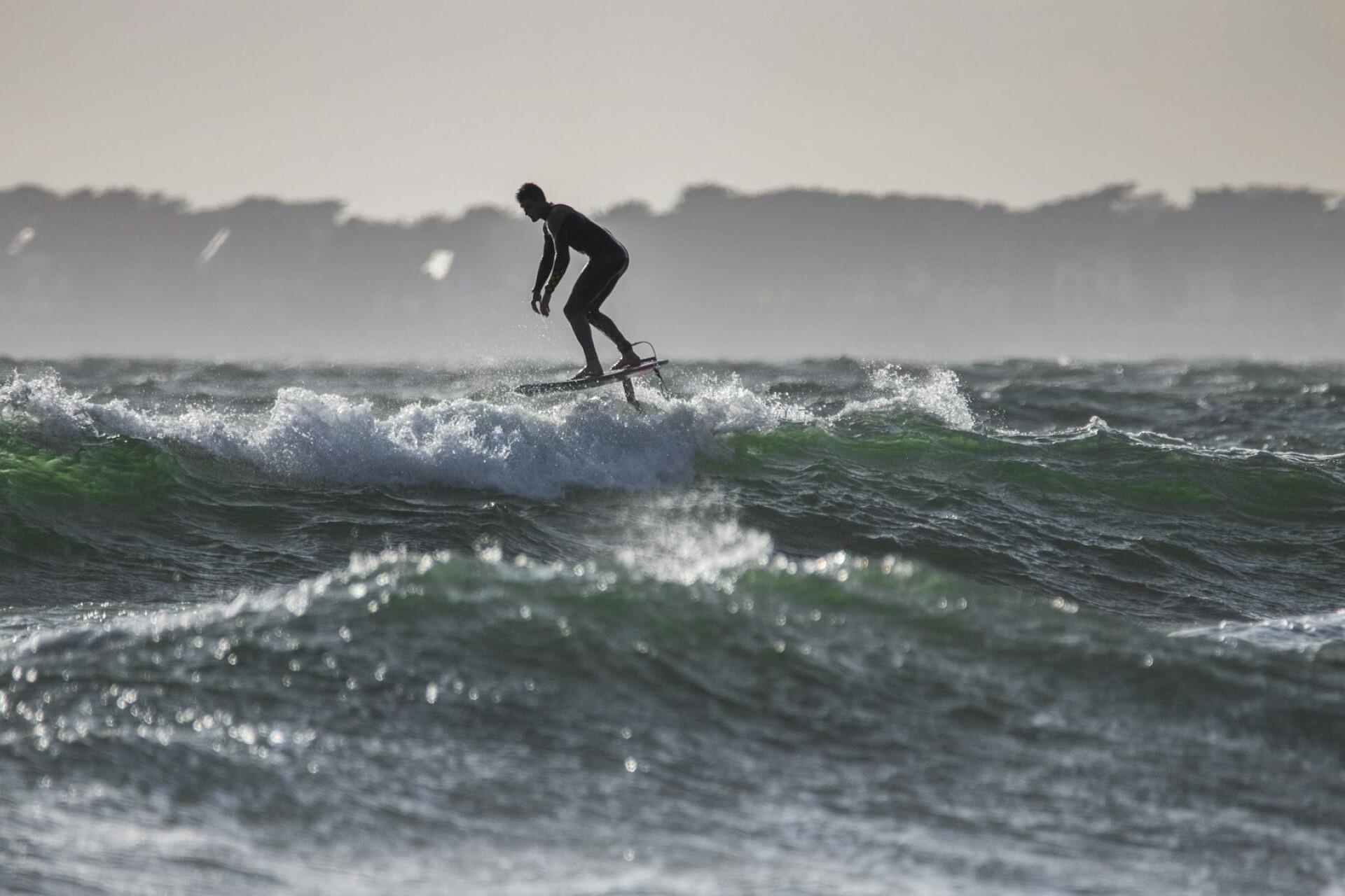 A person foil surfing.