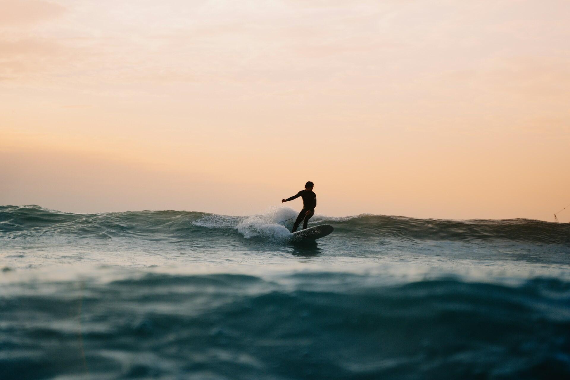 A person longboard surfing.