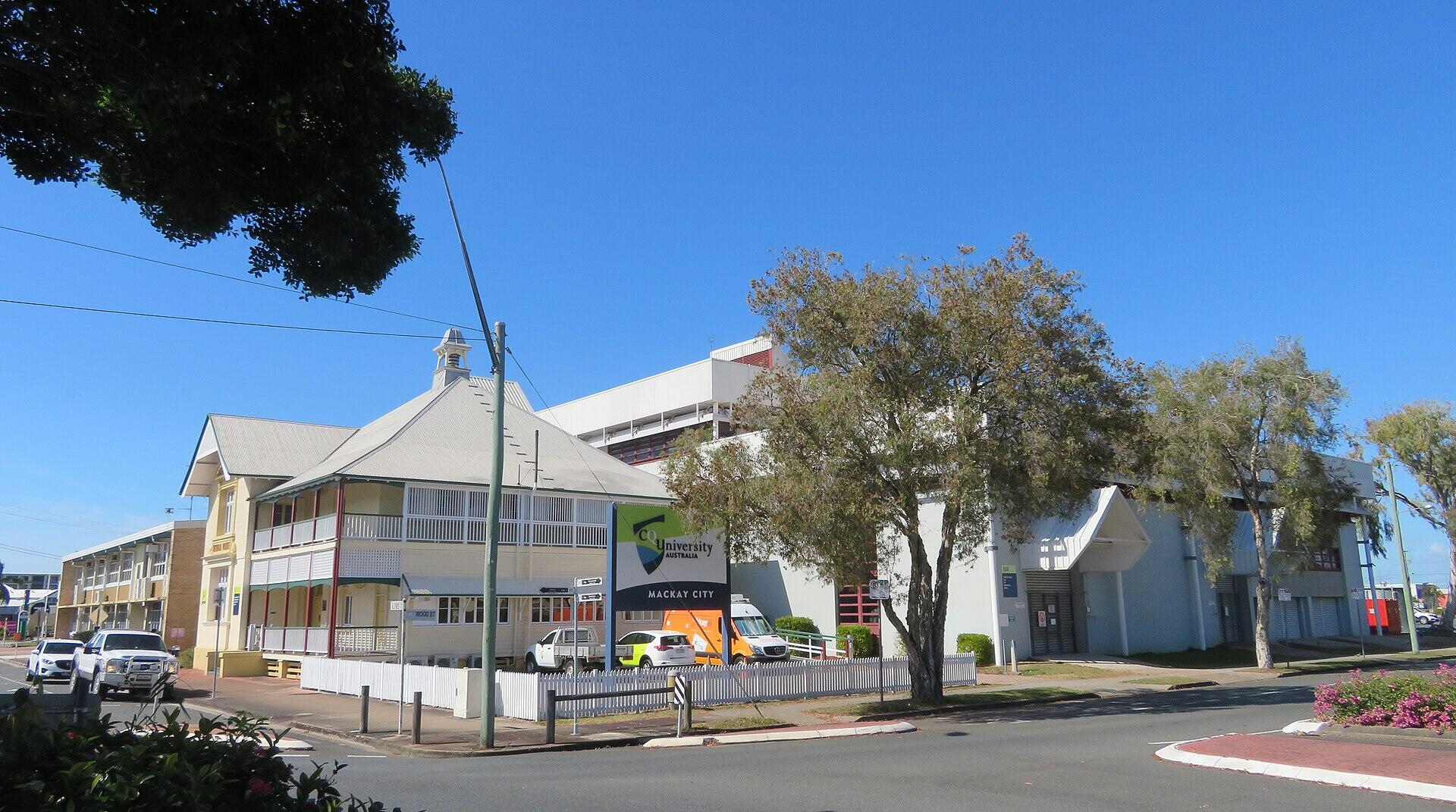A collection of low white buildings on a sunny day.