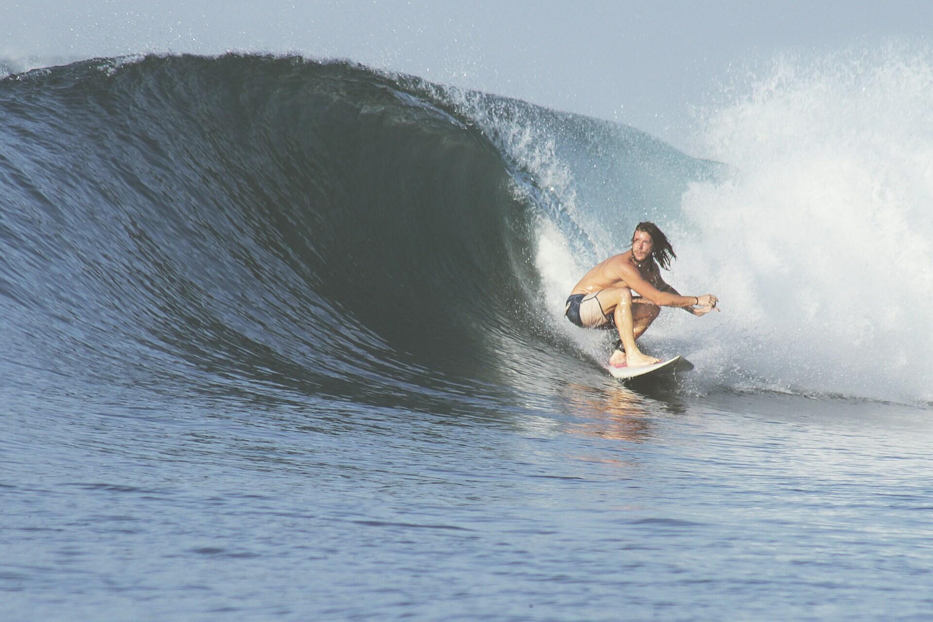 A man surfing on a wave.