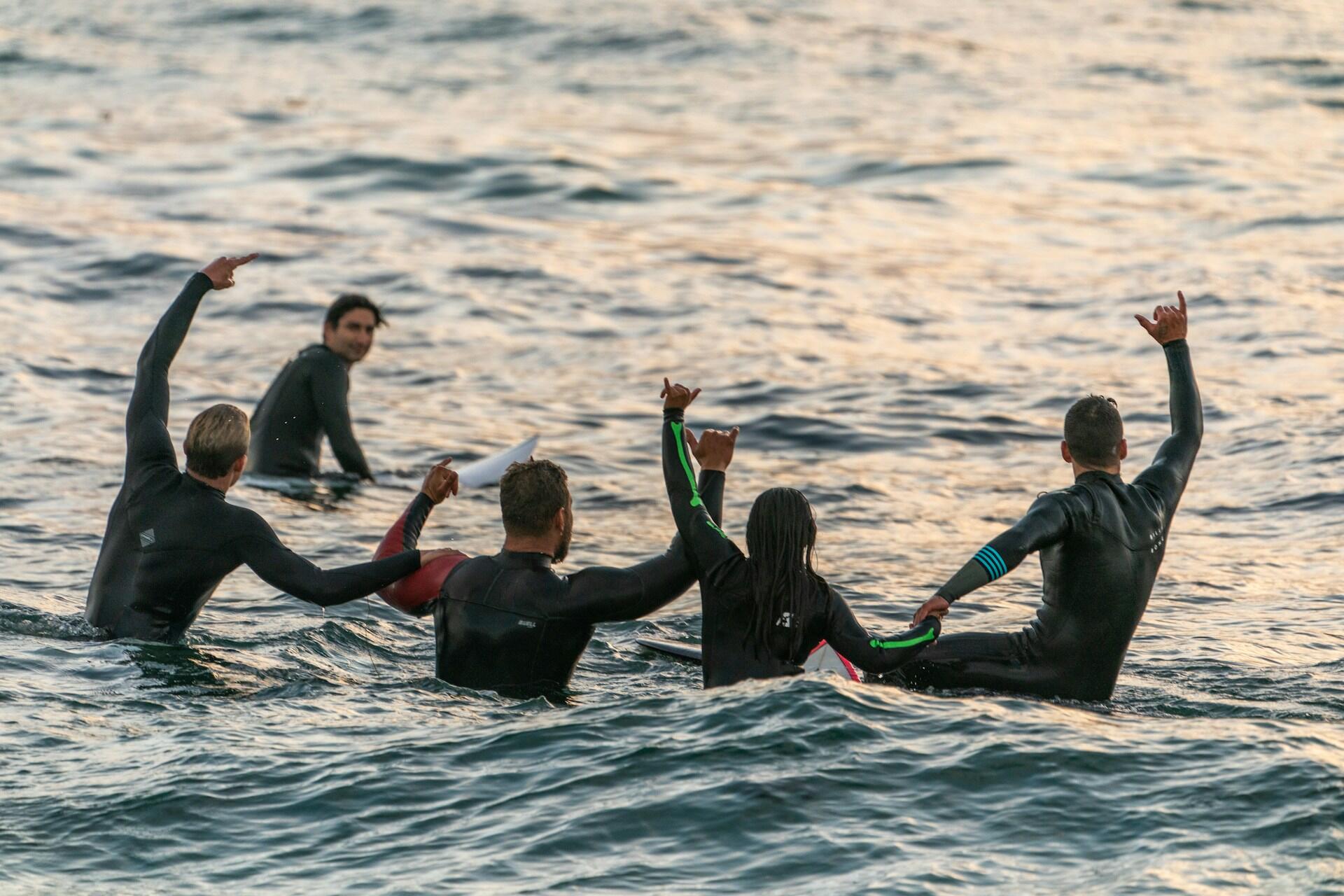 Surfers celebrating on the water.