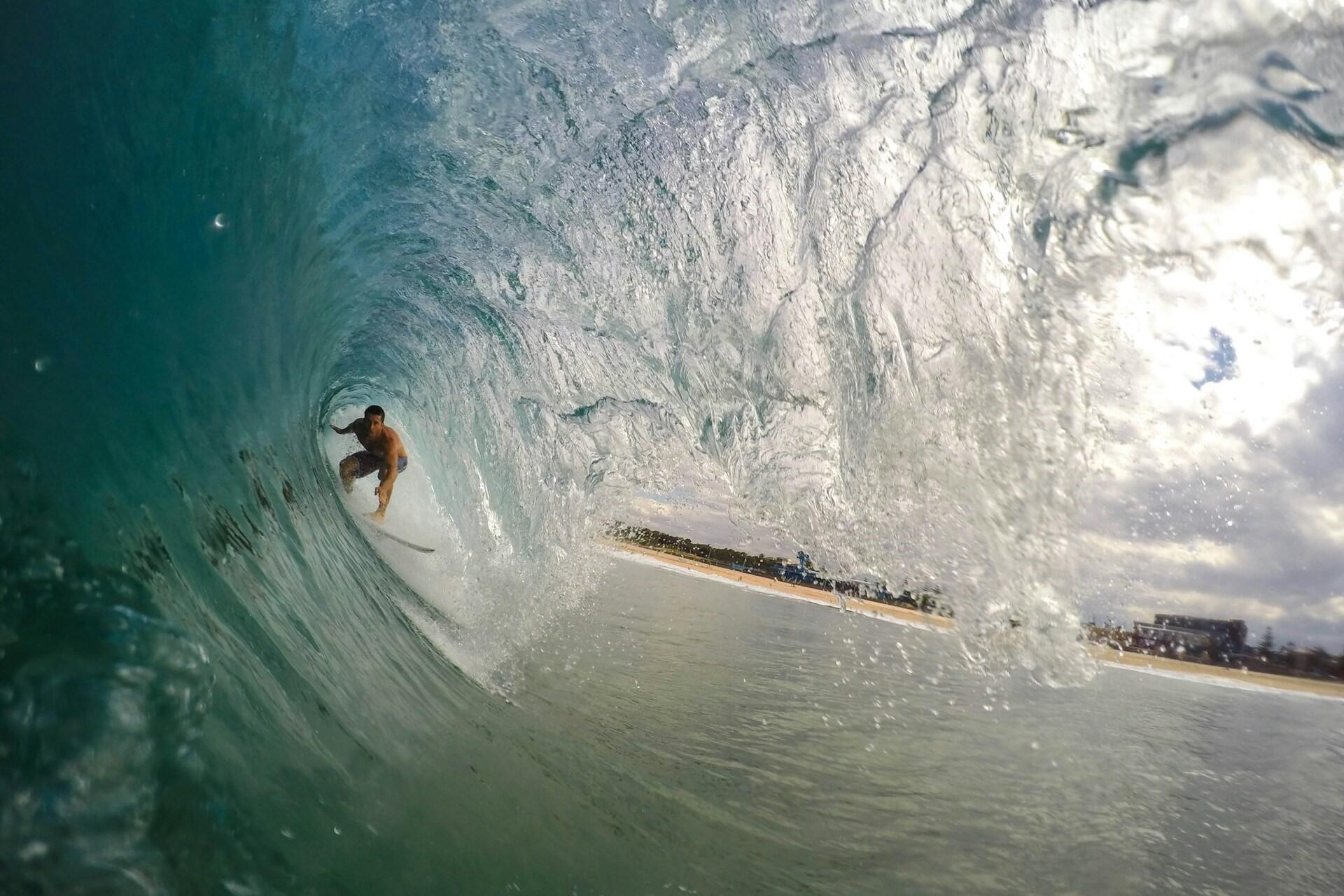 A surfer surfing within a wave.