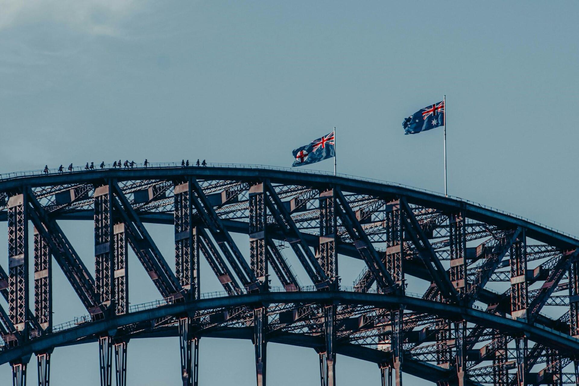 Sydney Harbour Bridge flying the Australian flag and the flag of New South Wales.