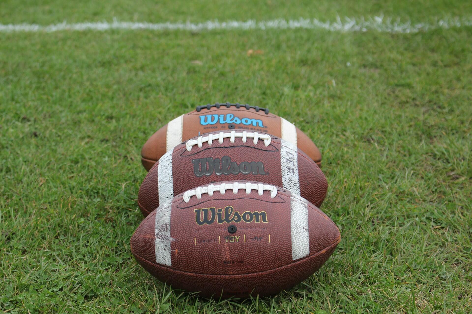 Three NFL footballs.