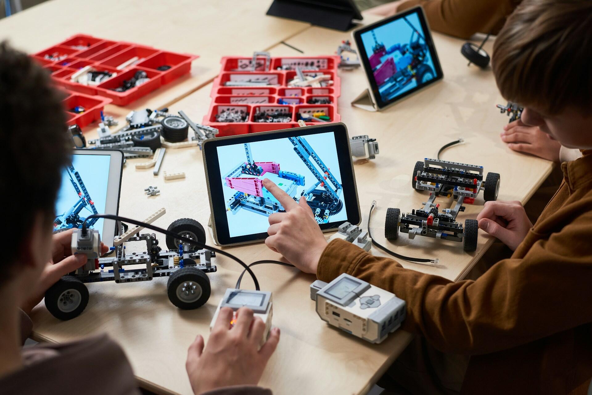 group of students developing a small car with CAD software and physical parts