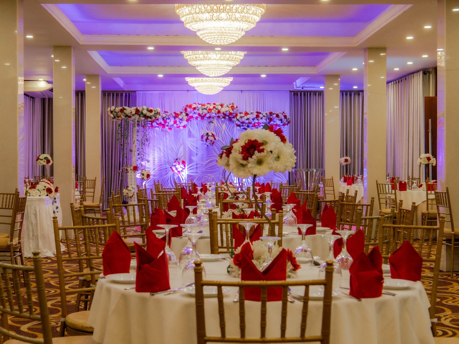 A banquet hall with tables ready to greet guests. 
