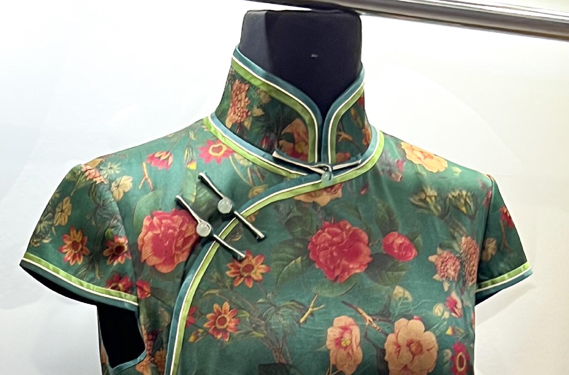 A green garment with short sleeves and a high neck. 