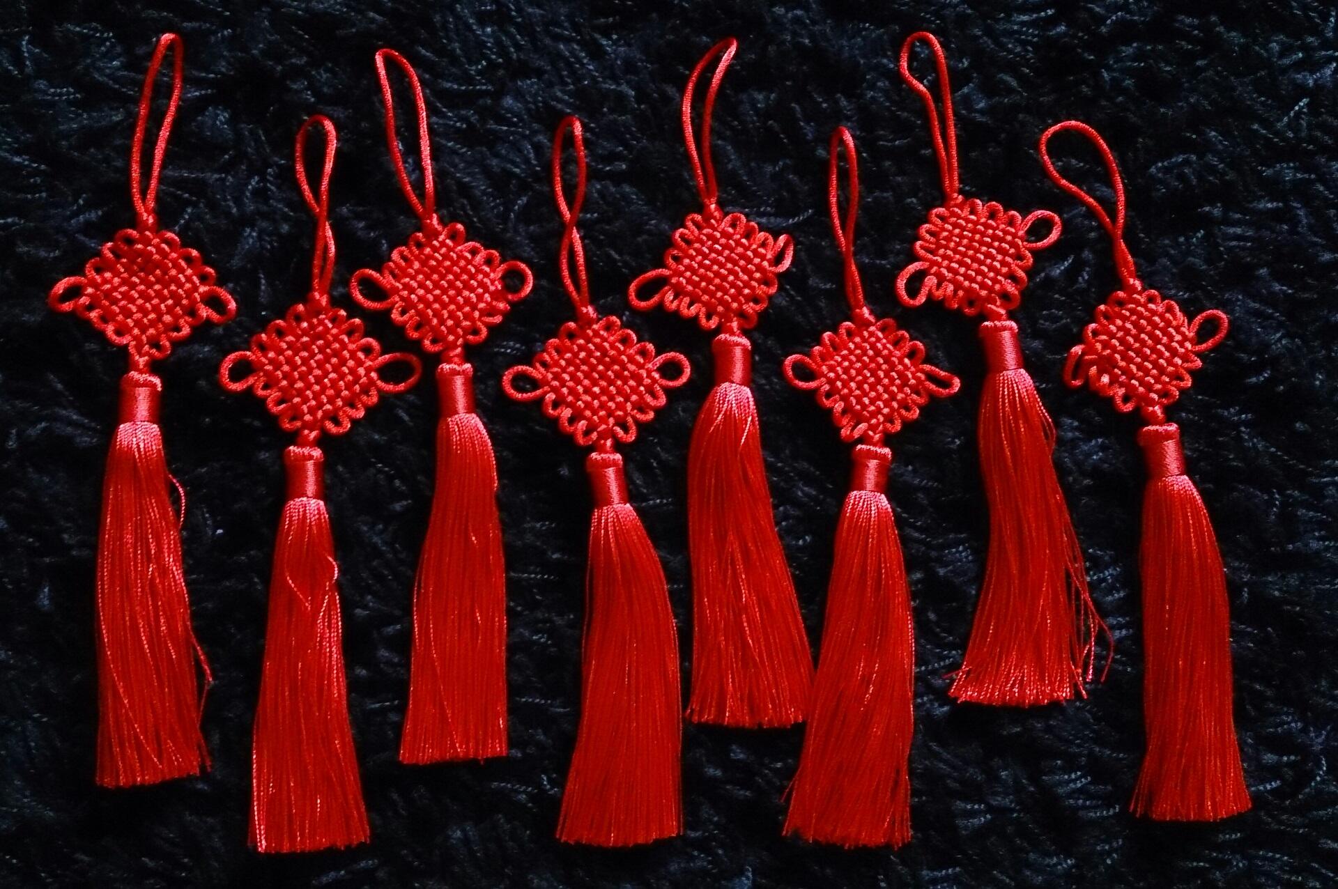 Eight red Chinese knots with tassels. 