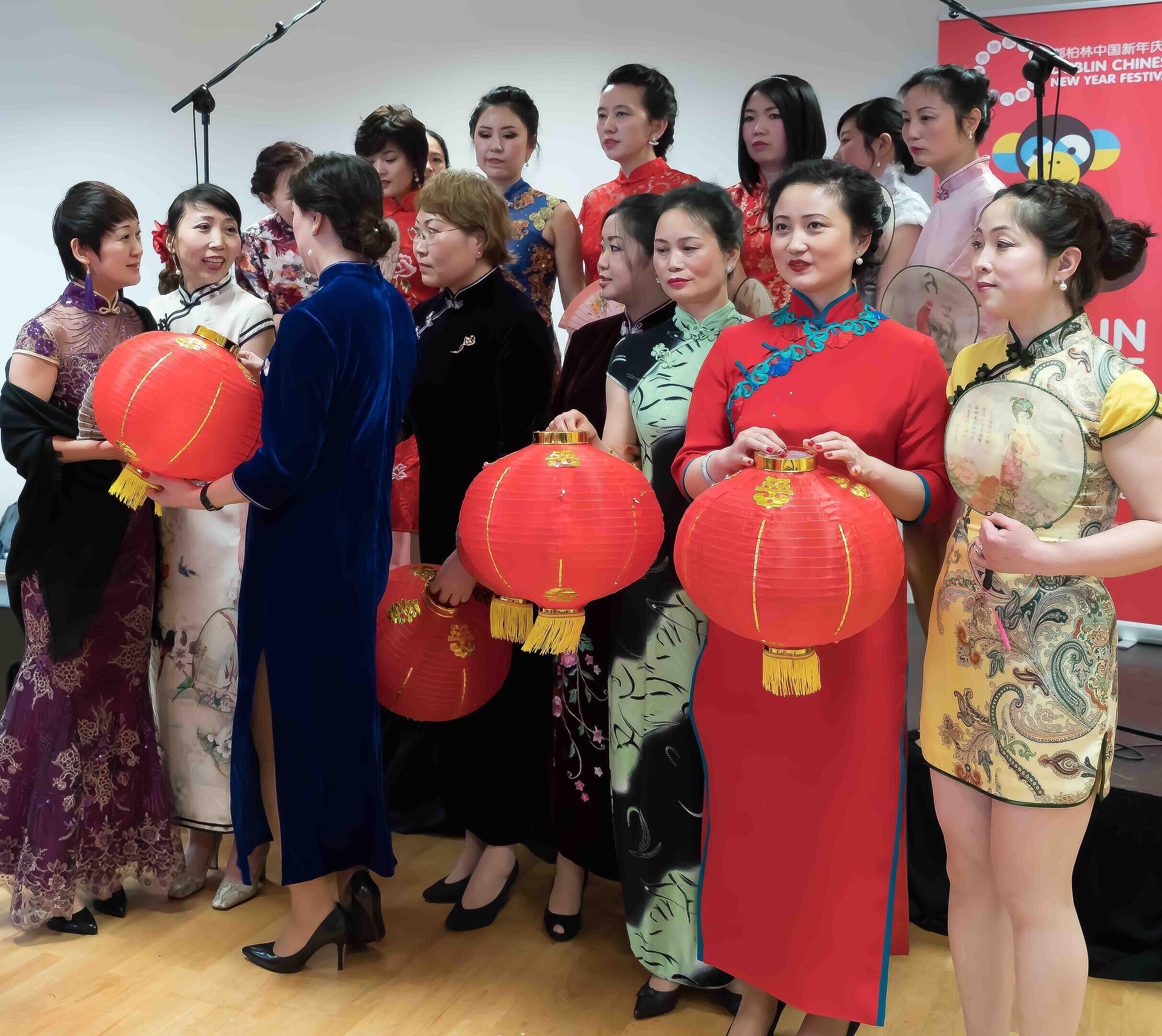 A group of women wearing various versions of qipao.