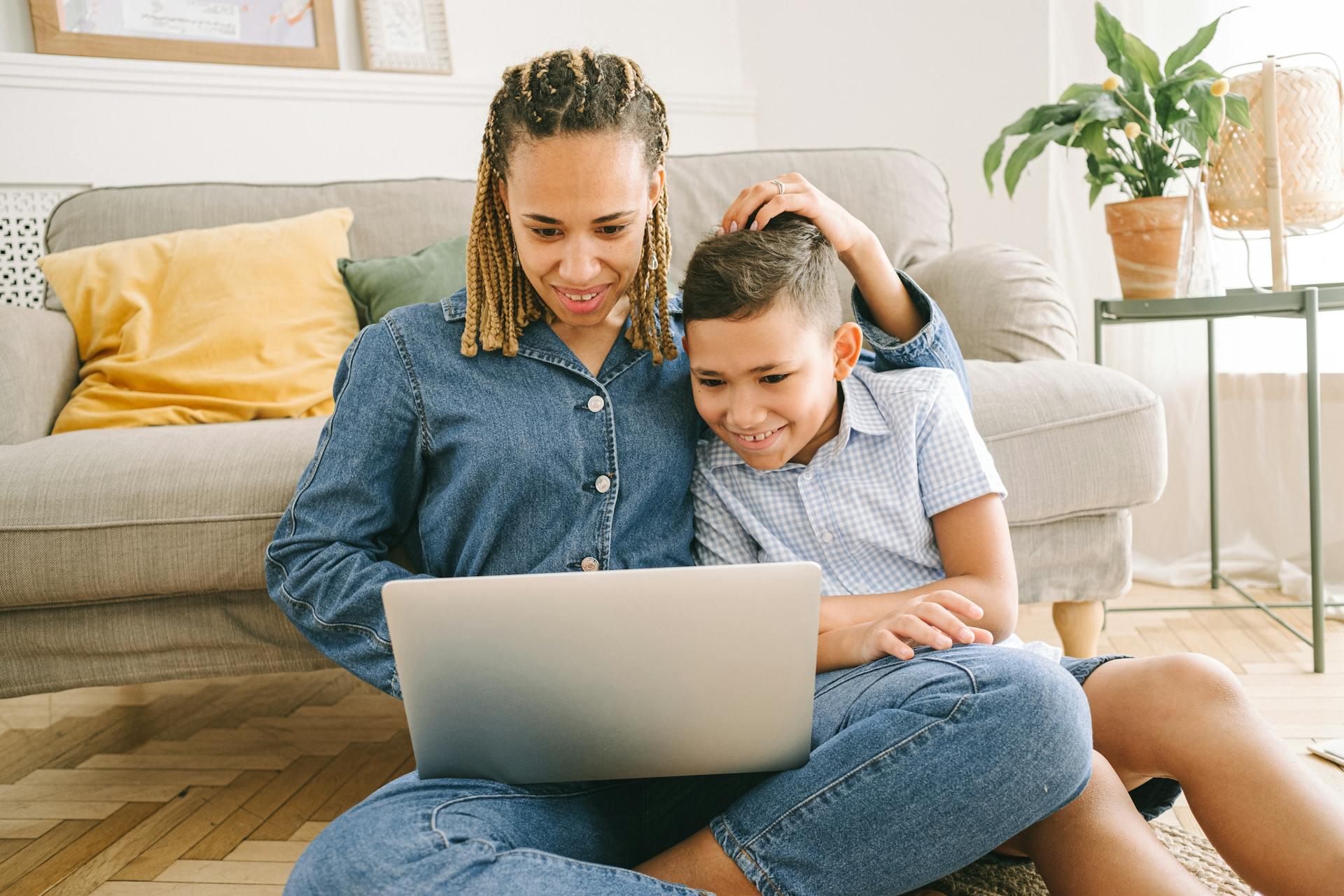 mother and young child looking at computer together