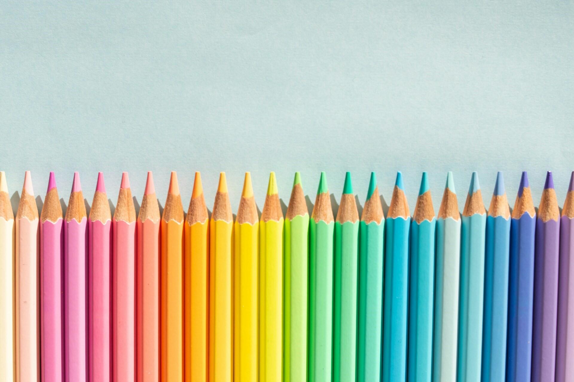 Coloured pencils in a row.