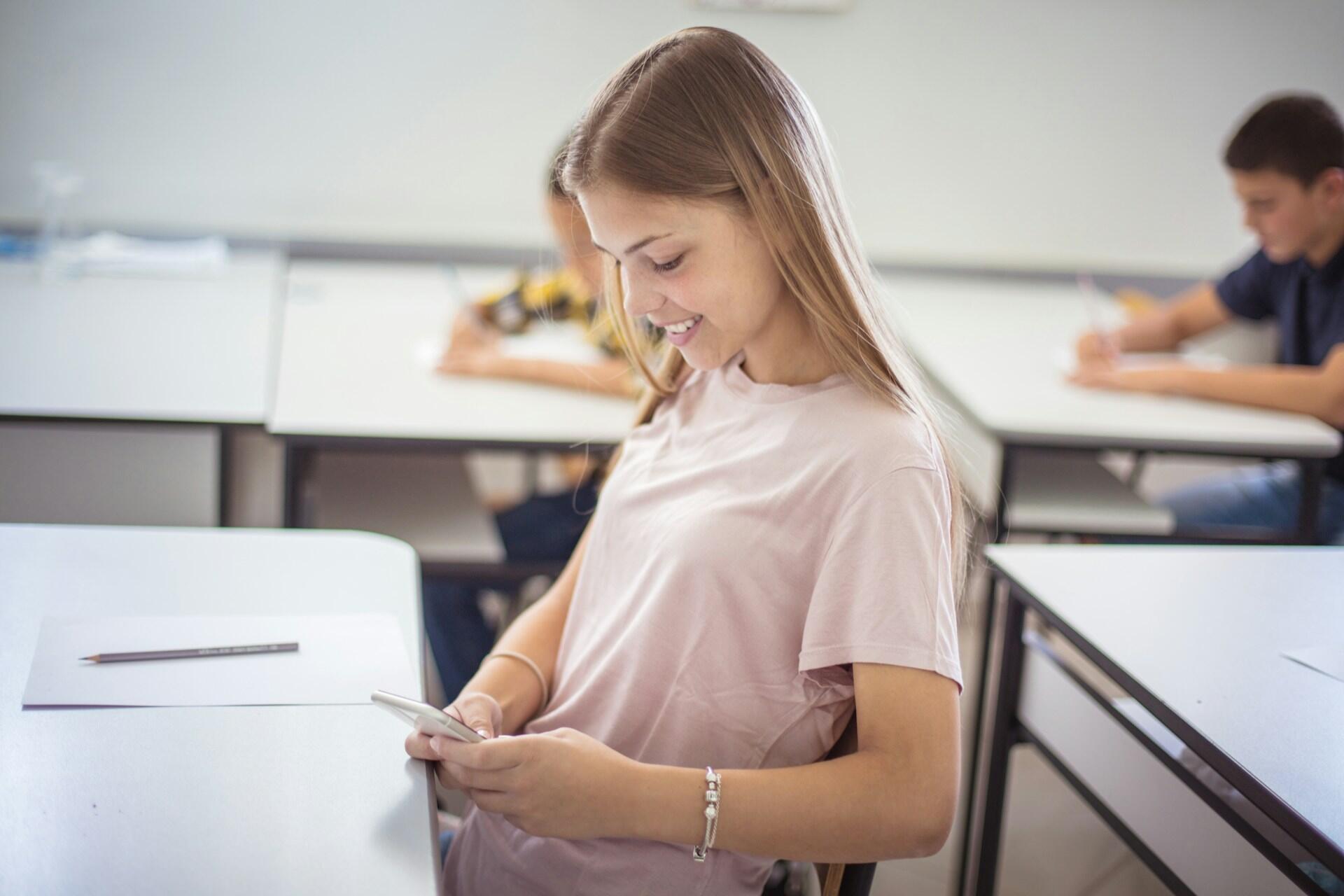 teen using a phone in class
