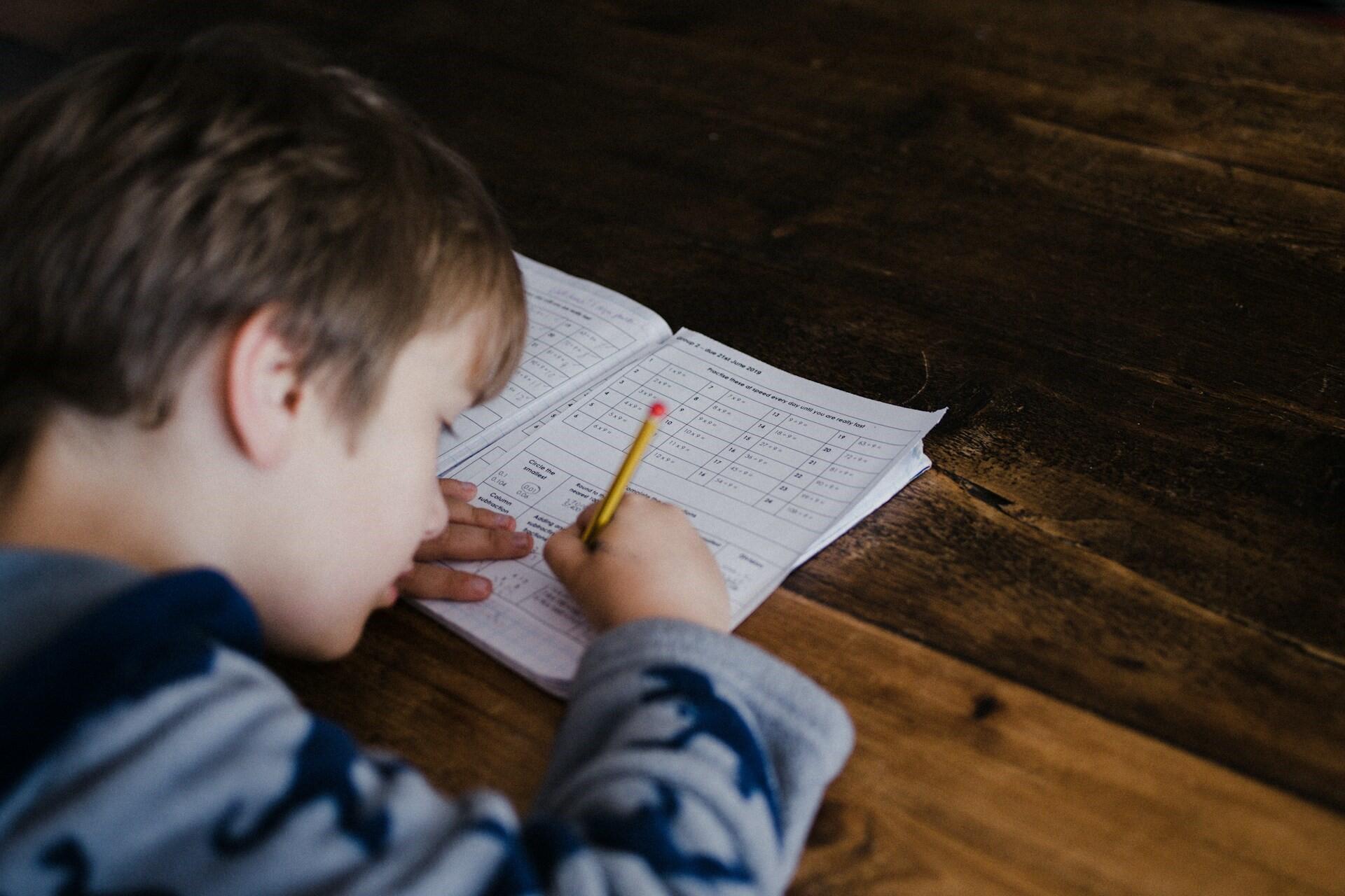 A young pupil writing.
