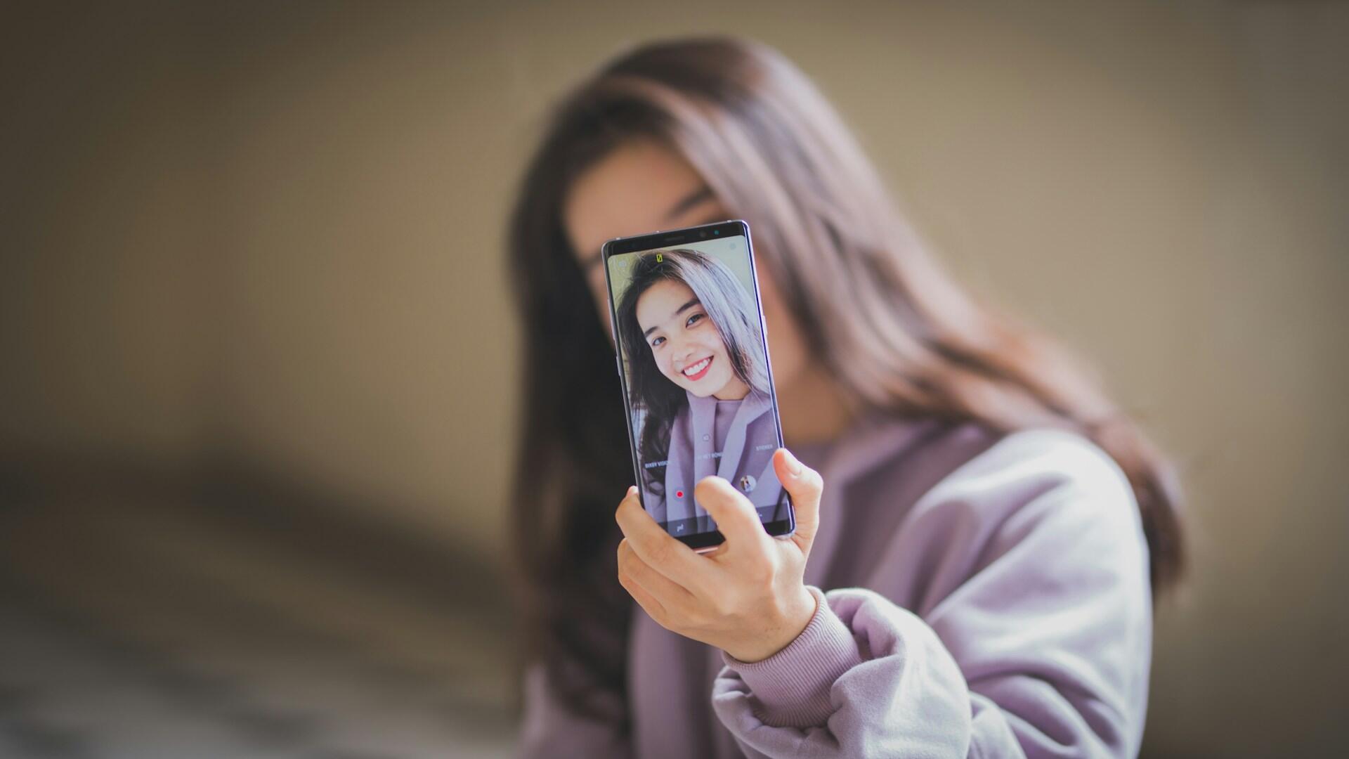 girl taking a selfie on phone