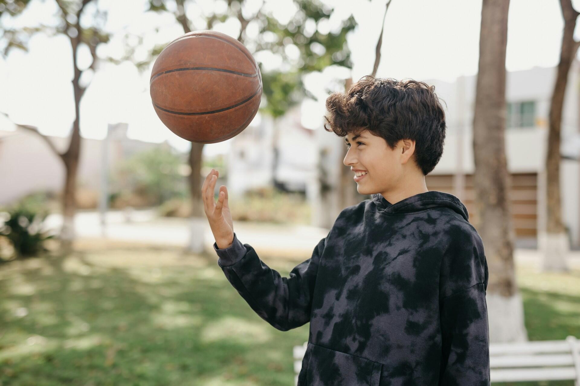 teen playing basketball