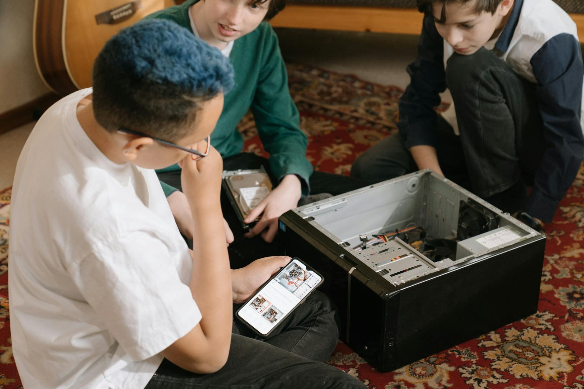 a group of teens looking up how to build a computer online