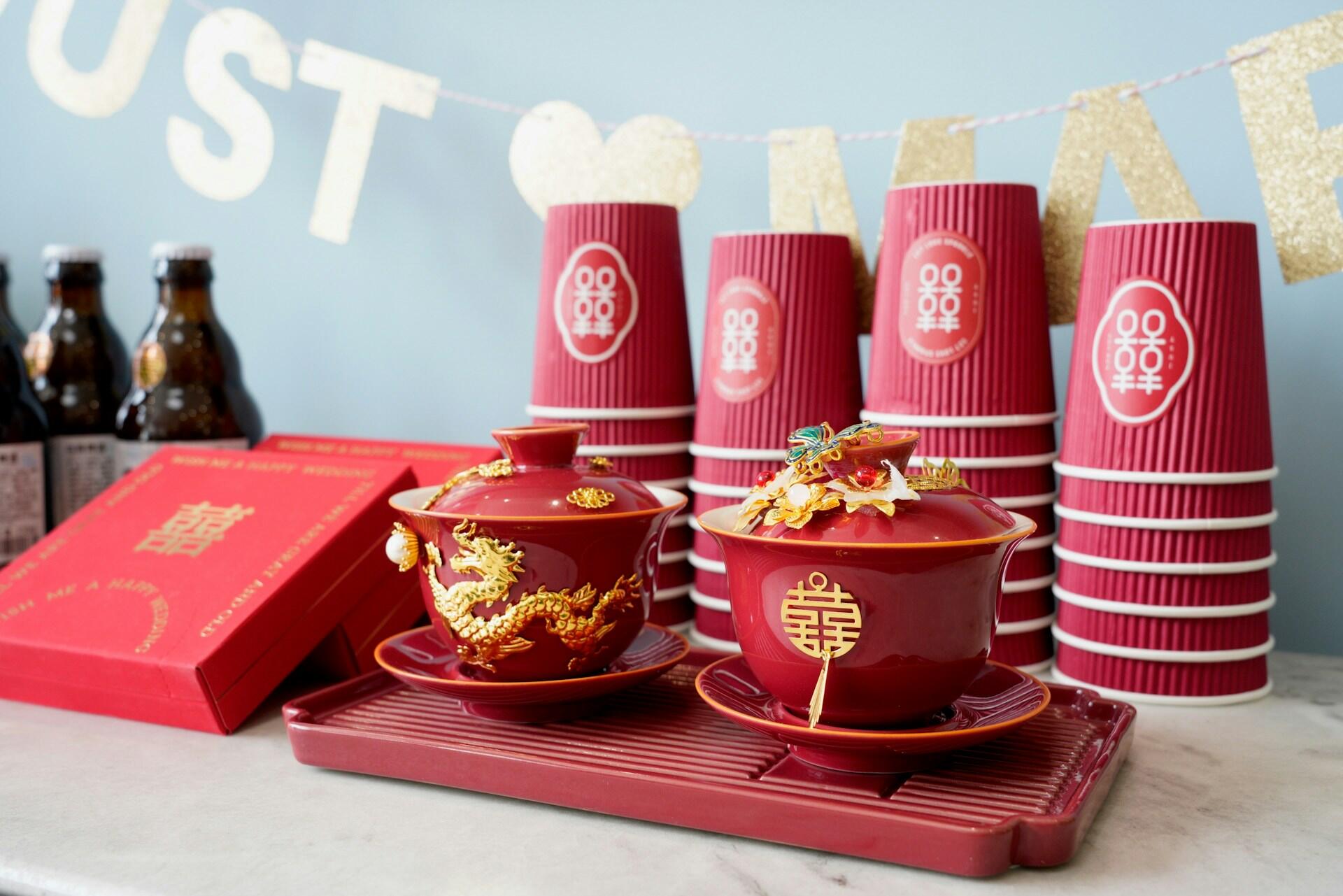 Red paper cups and dishes with gold decorations.