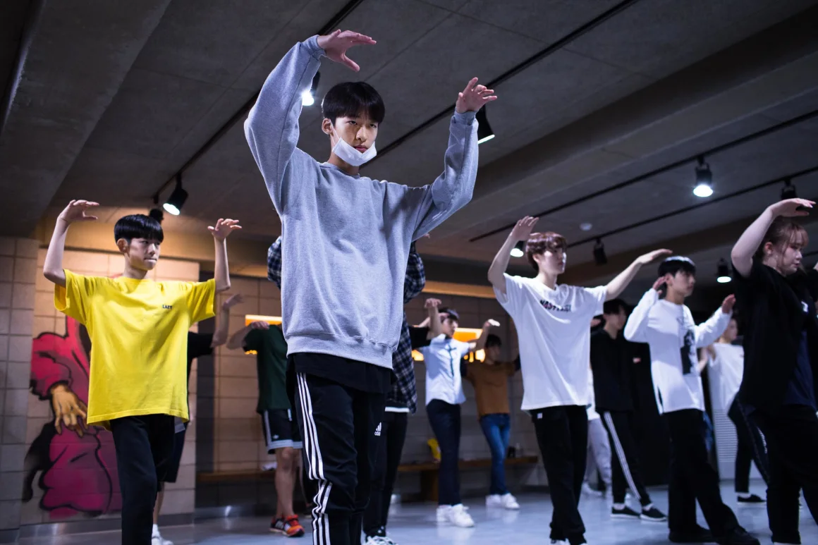 group of teens practicing dancing in a studio
