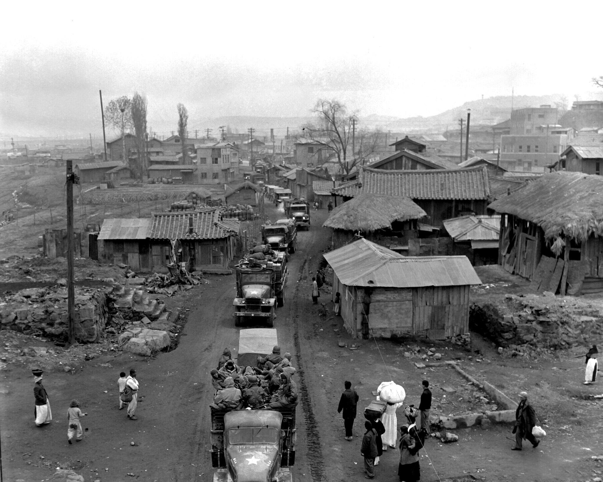 A convoy of withdrawing UN troops wait to cross the Han River Bridge at Seoul, Korea.