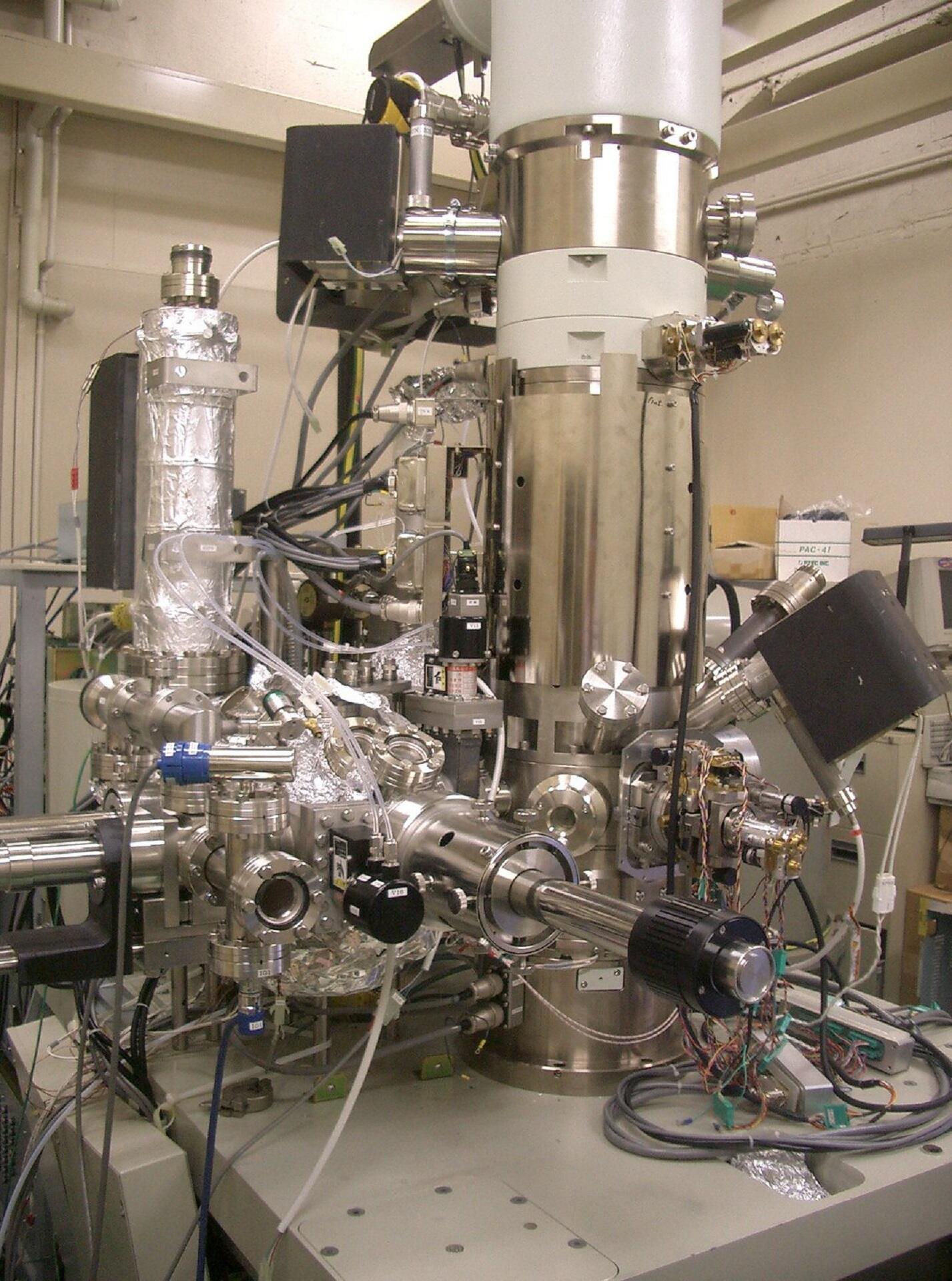 A large silver machine with many chambers in a lab.