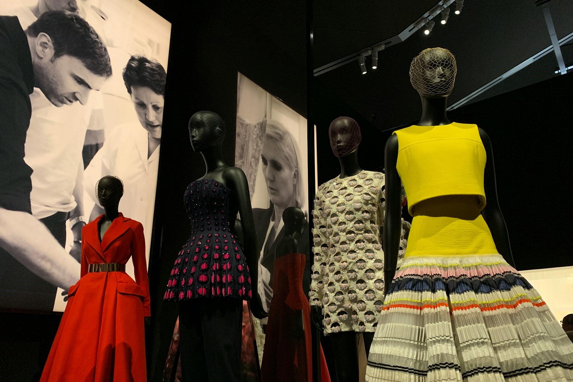 Mannequins wearing colourful designer garments displayed in a fashion exhibition space
