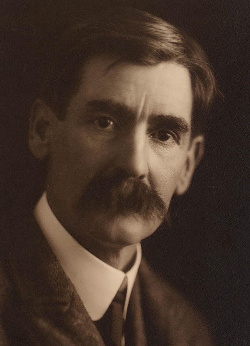 sepia portrait photo of Henry Lawson with a large mustache