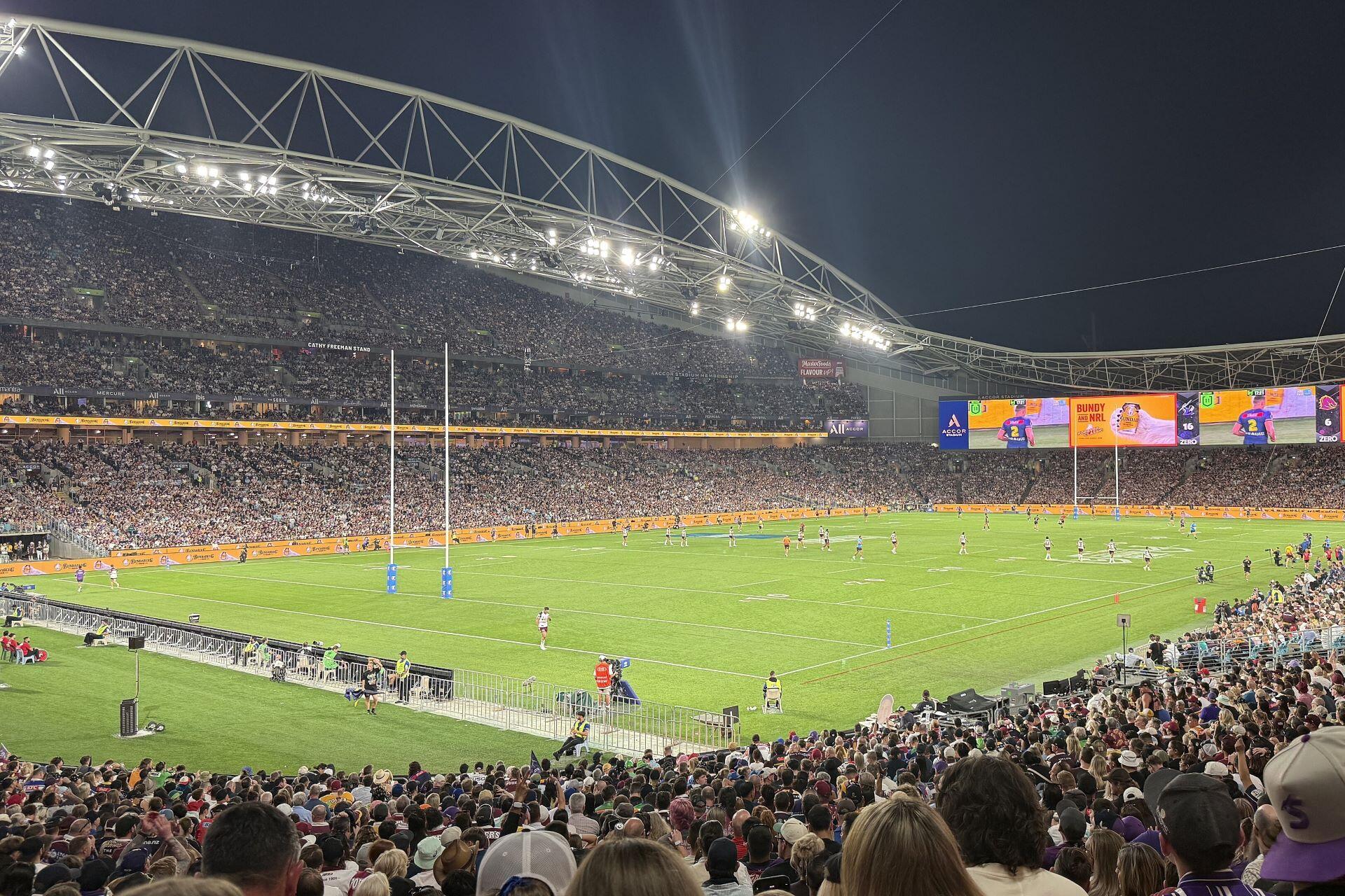 Supporters watching the 2025 NRL Grand Final between Brisbane Broncos and Melbourne Storm at Accor Stadium