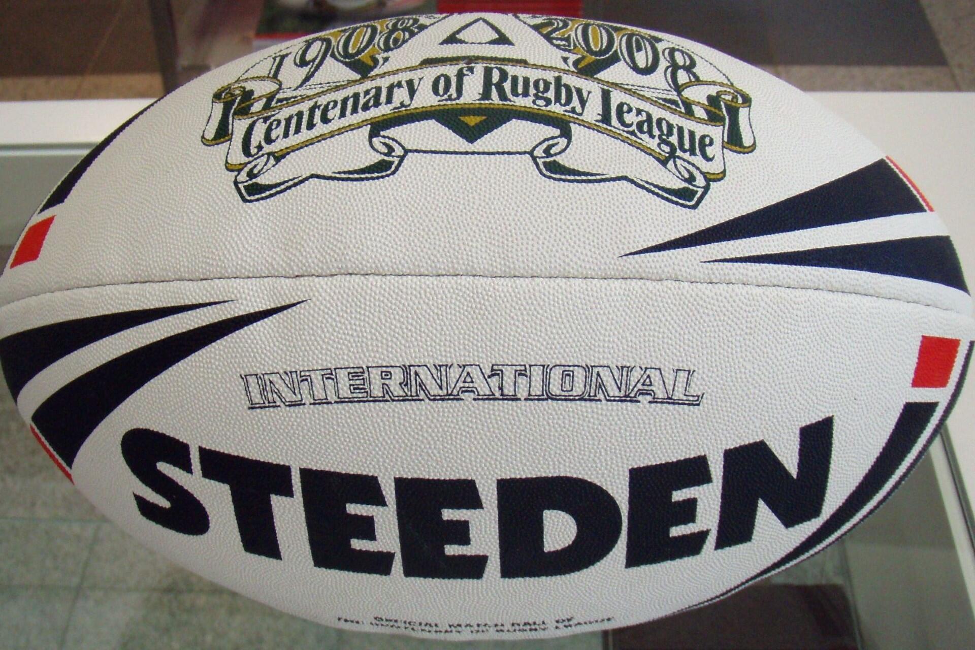 Close-up of a Steeden rugby league ball with centenary branding