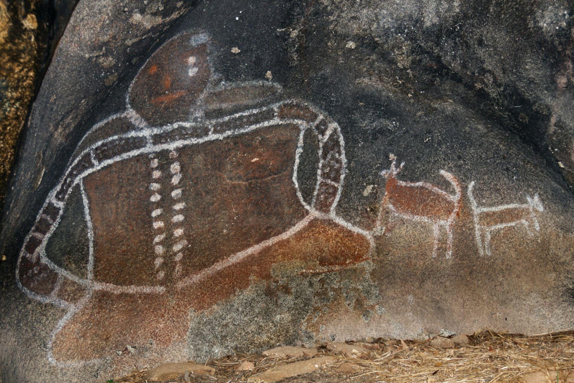 Aboriginal rock art depicting human figures and animals painted on stone