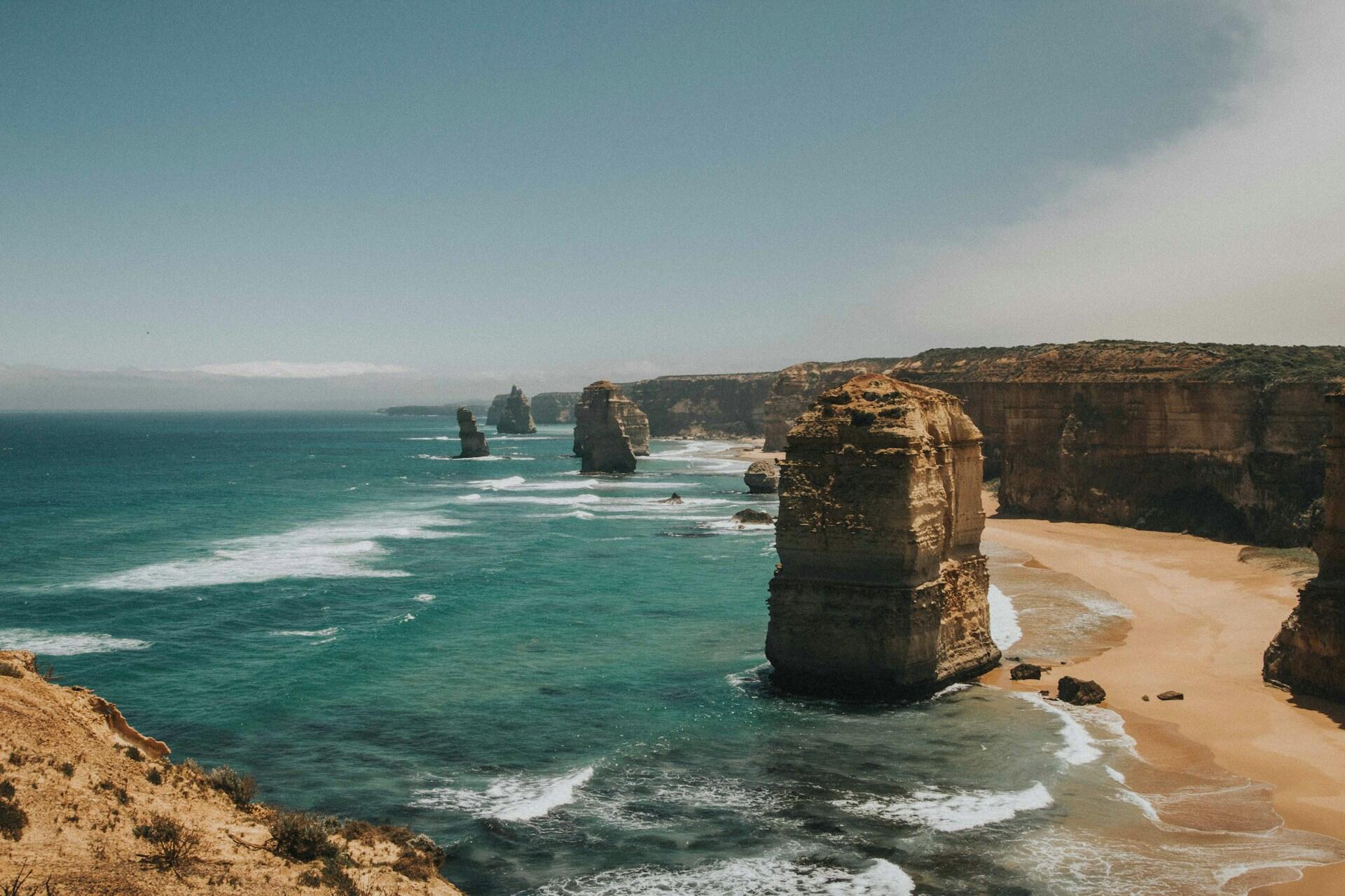 Rock formations and cliffs along the Great Ocean Road coastline with ocean waves