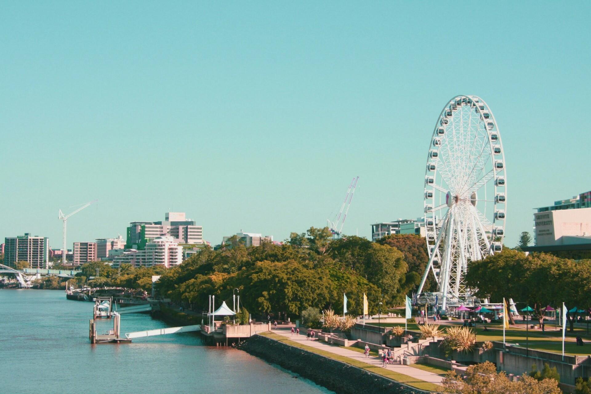 Brisbane skyline with South Bank ferris wheel and riverfront park along the Brisbane River