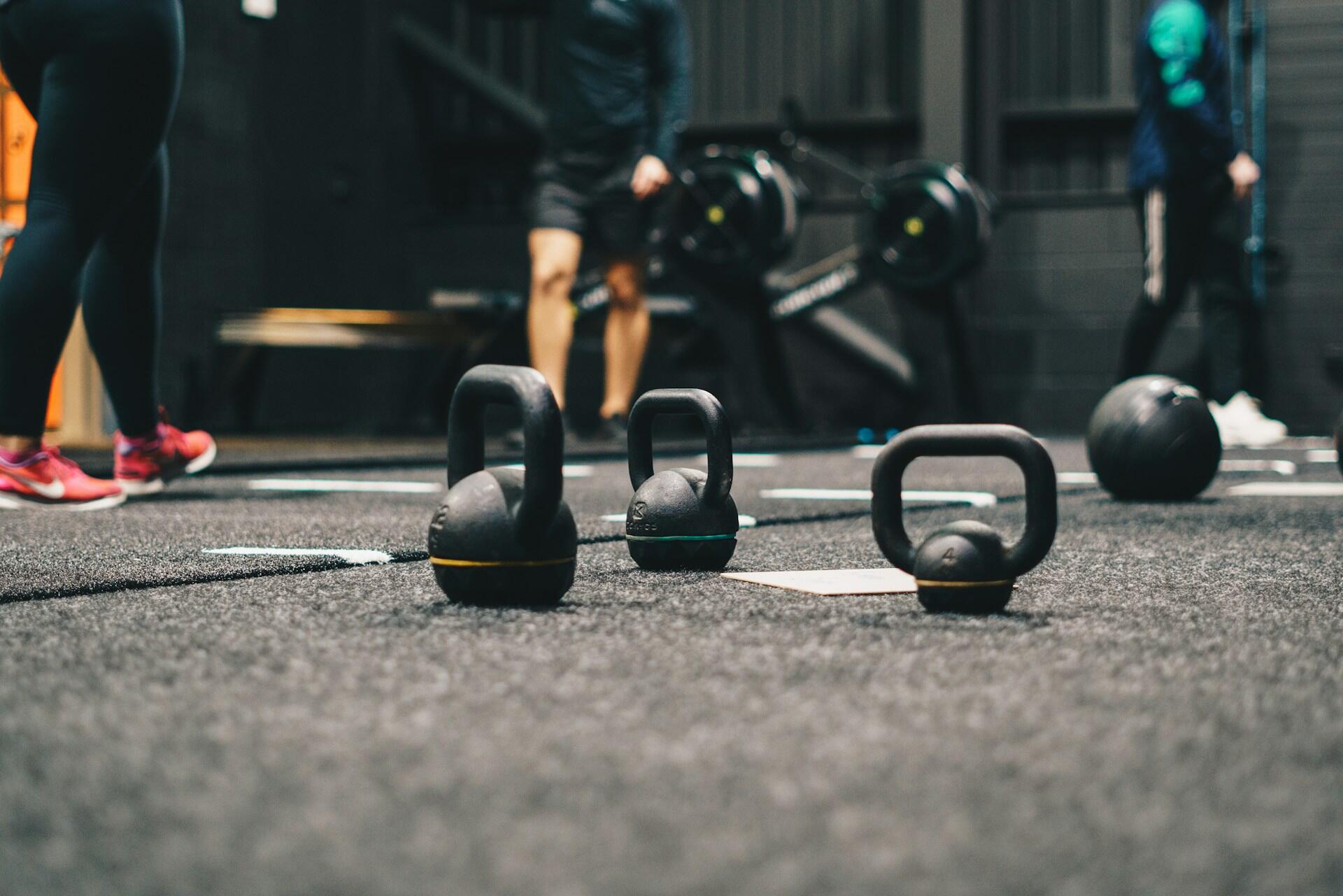 Kettlebells on a gym floor during a functional strength training session