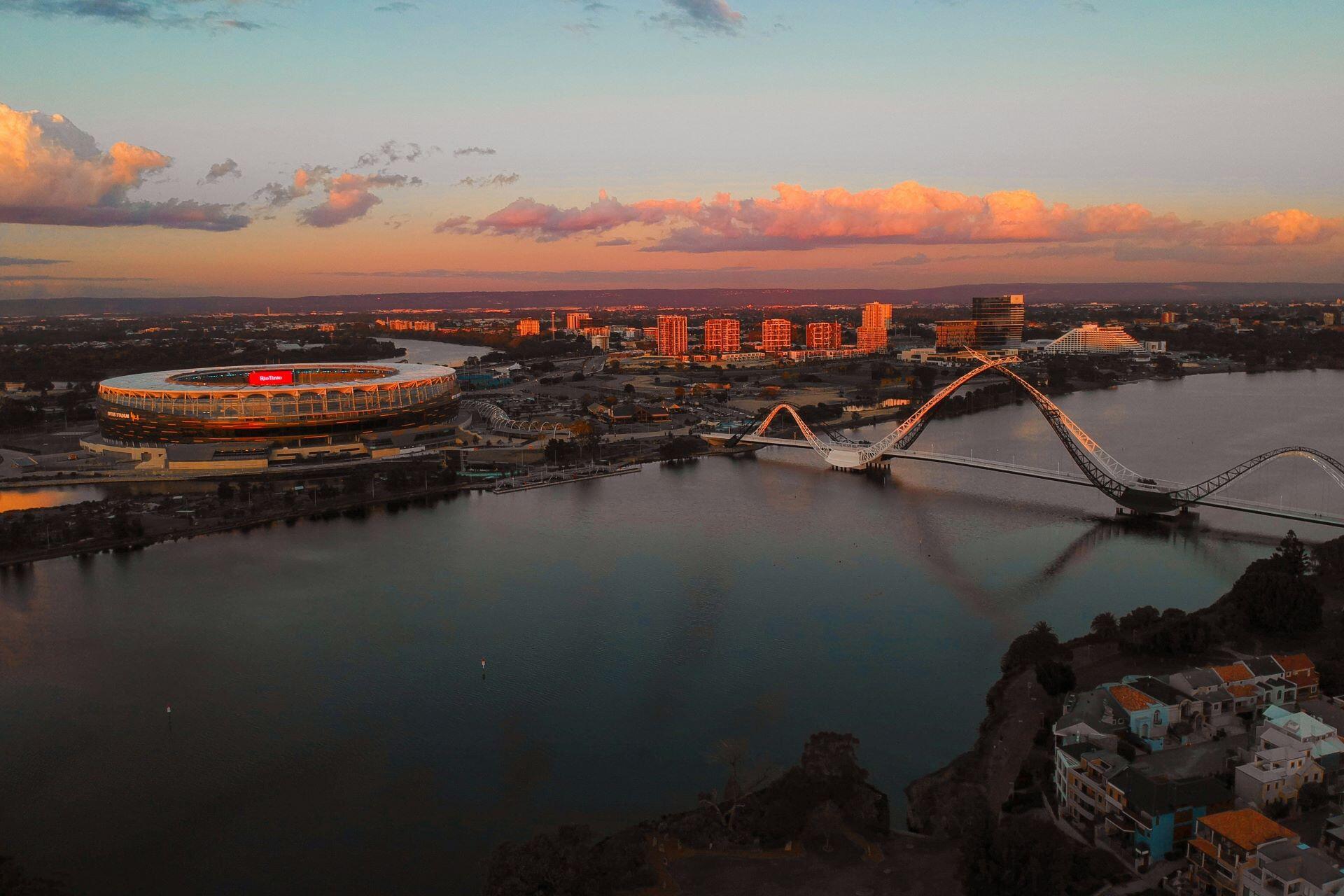 Aerial view of Perth skyline and Matagarup Bridge at sunset in Western Australia