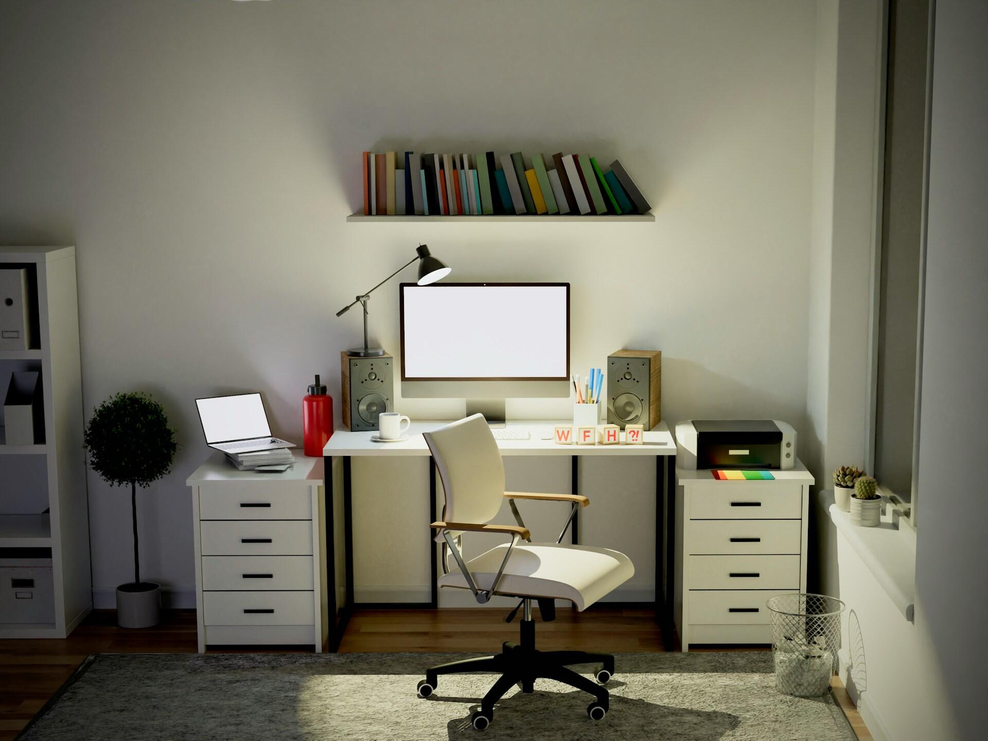 A white desk with elegant lines is lit up by a table lamp. The computer monitor is switched on and a small bookshelf hangs over the desk.